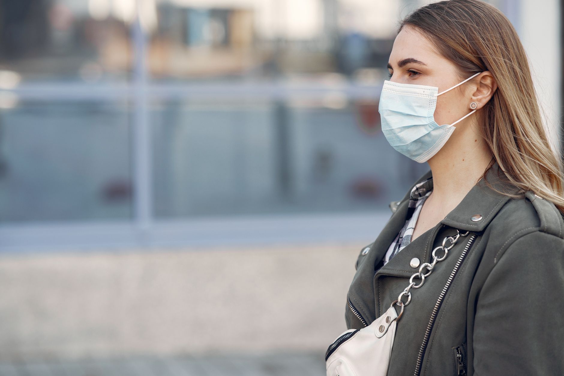 Person wearing a protective face mask while walking in a city
