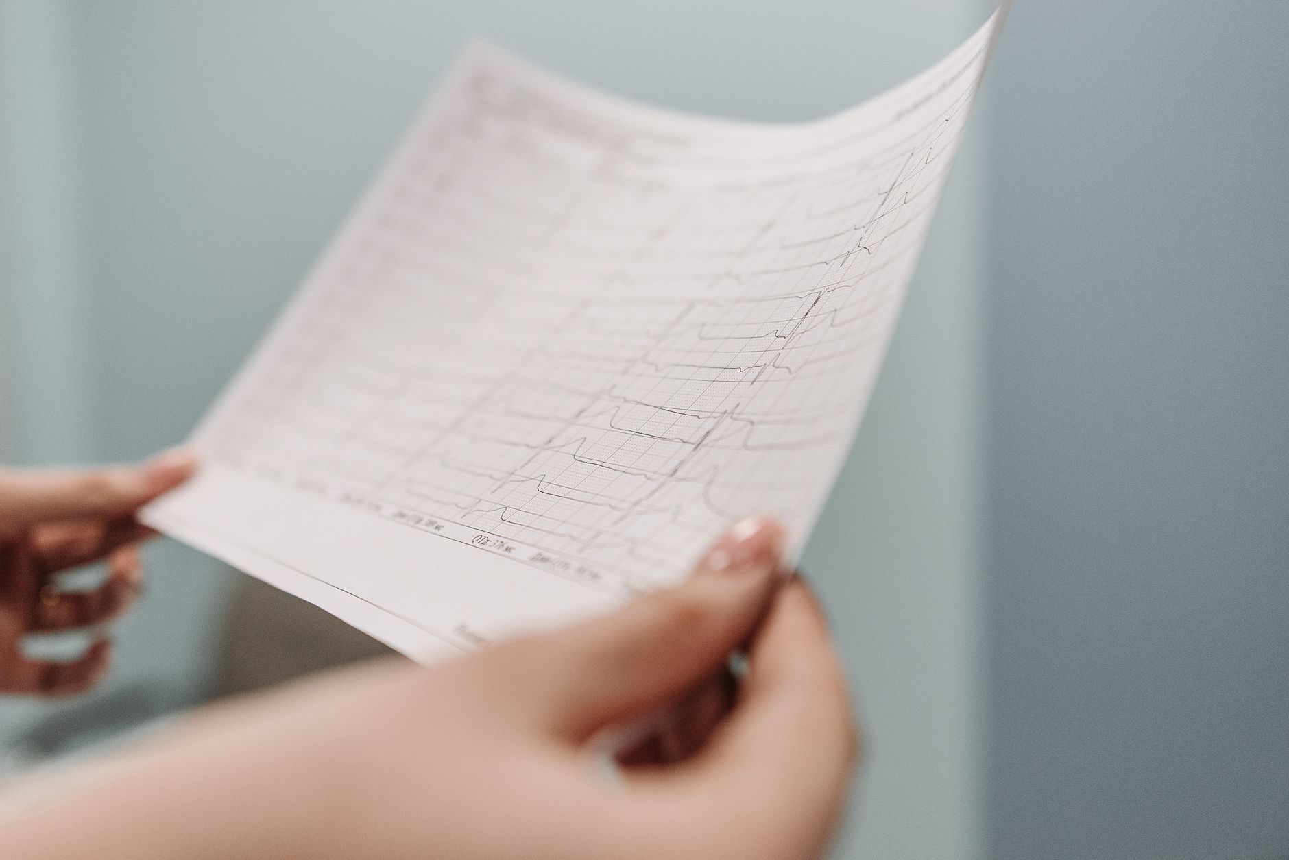 A cardiologist explaining heart test results to a patient in a clinic