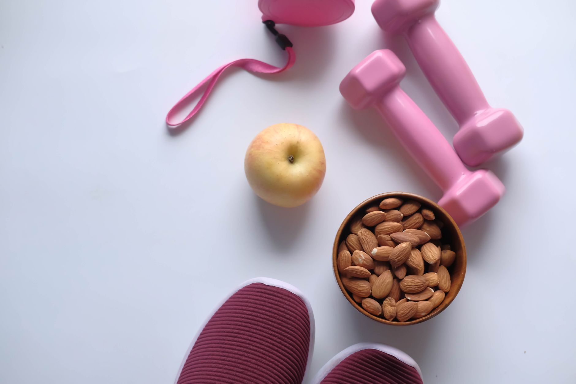 A flat lay of healthy foods and fitness accessories representing a heart-healthy lifestyle