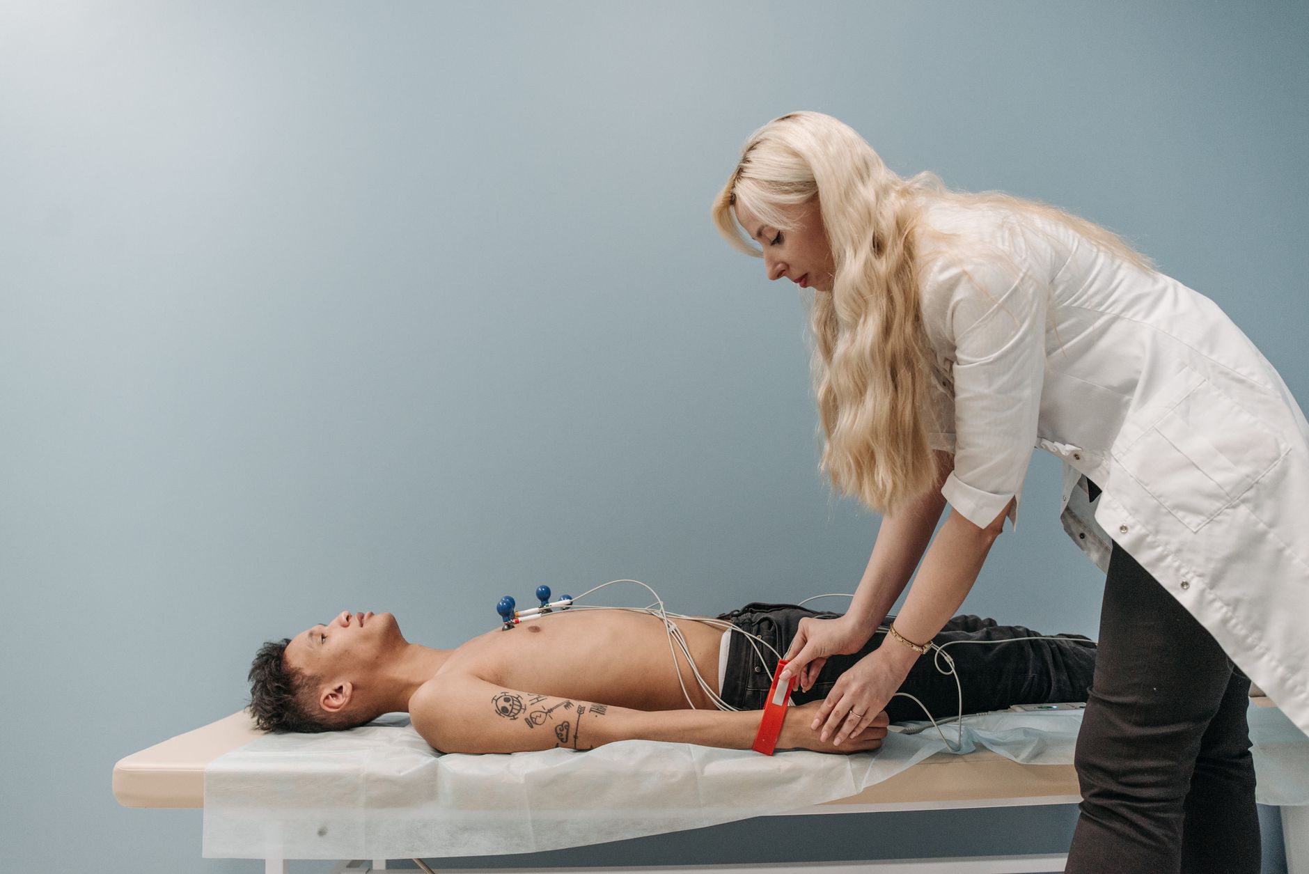 A patient resting comfortably on an examination table during a non-invasive cardiovascular test