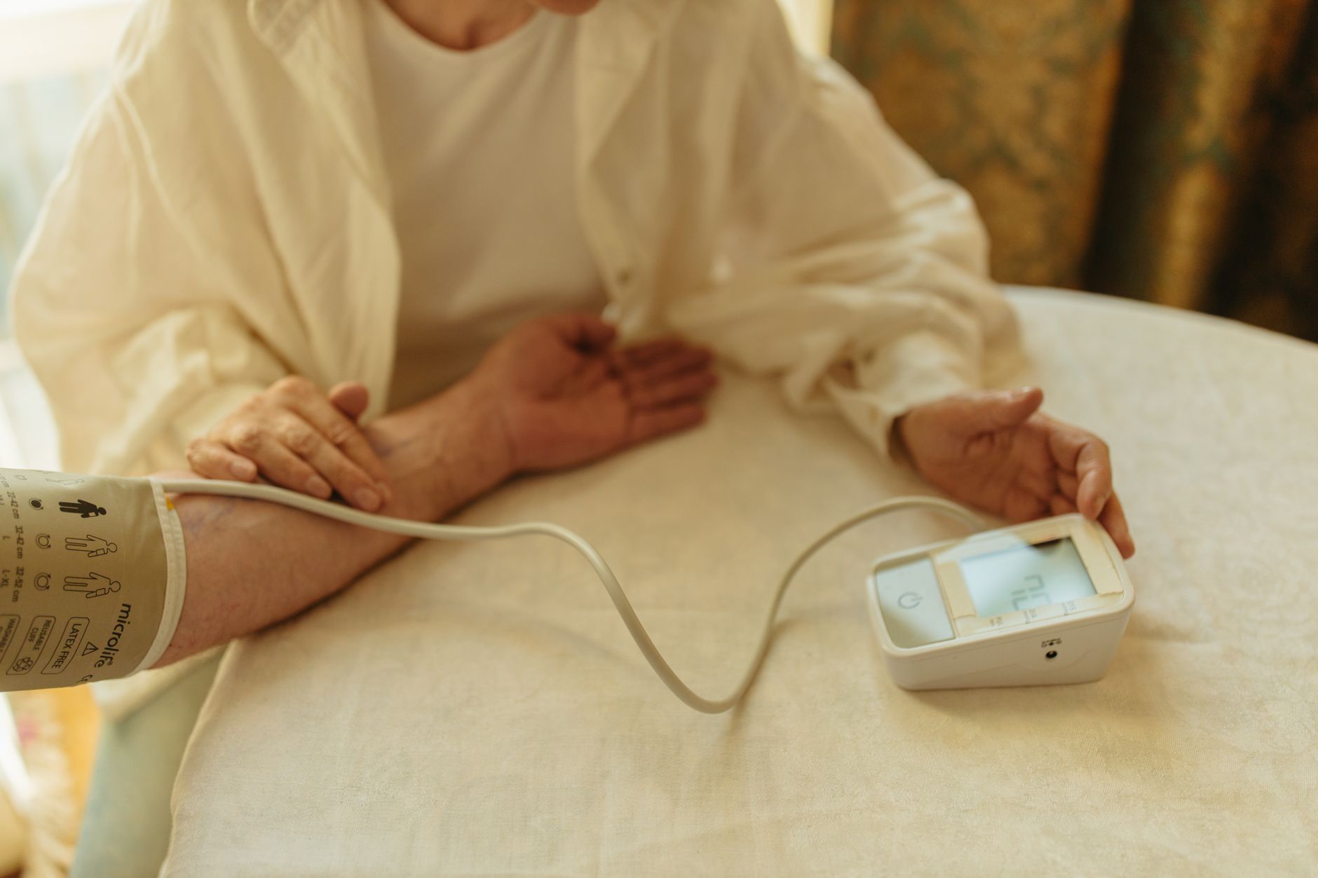 Person sitting relaxed and still in a chair before taking a blood pressure reading