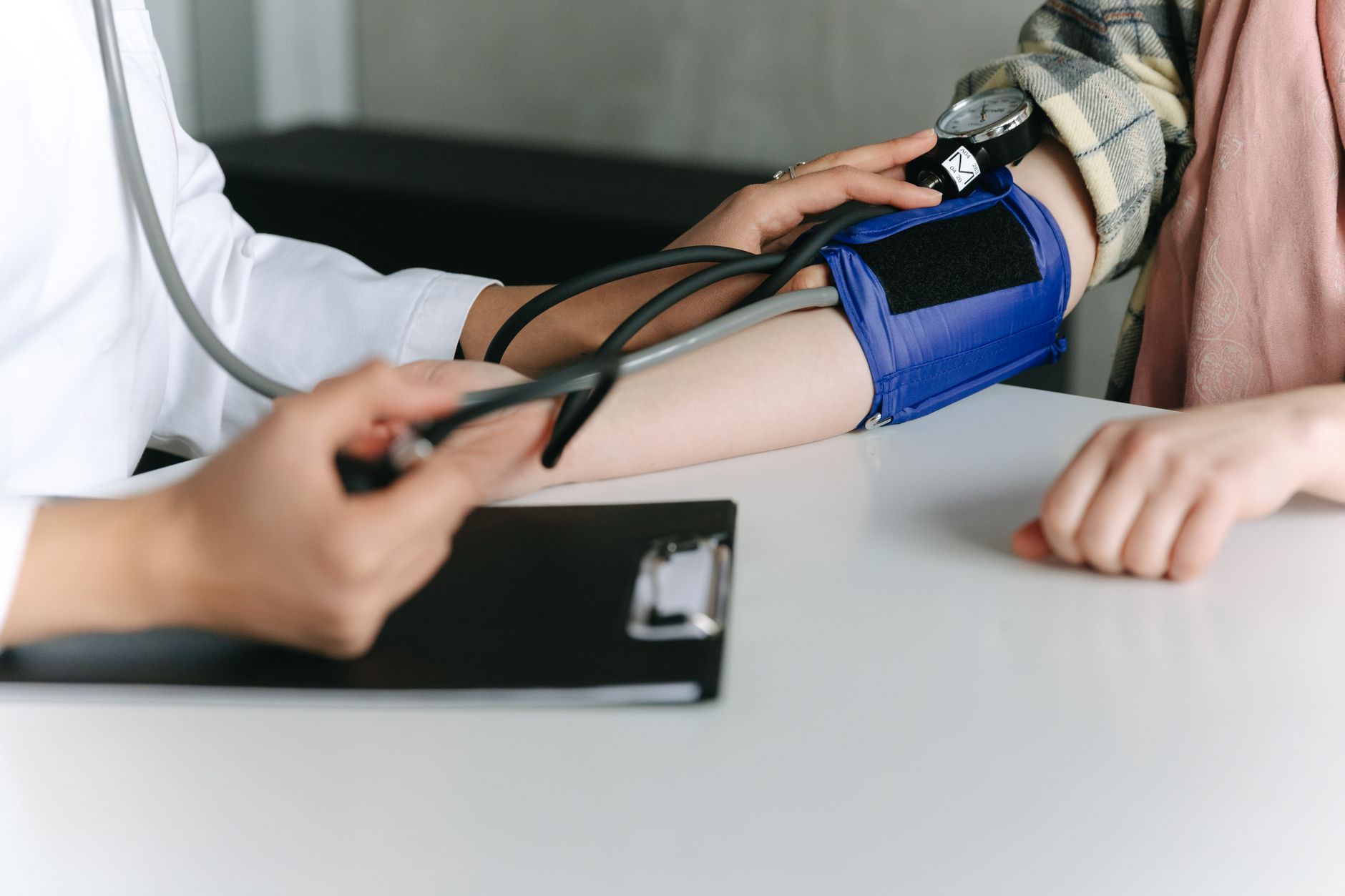 Cardiologist reviewing a patient's home blood pressure log during a consultation