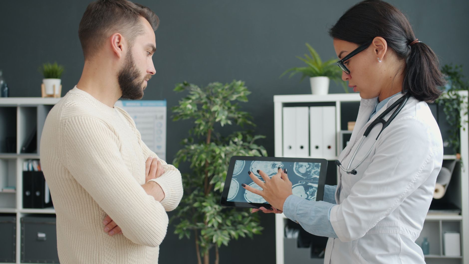 Doctor explaining heart scan results to a patient in a clinic