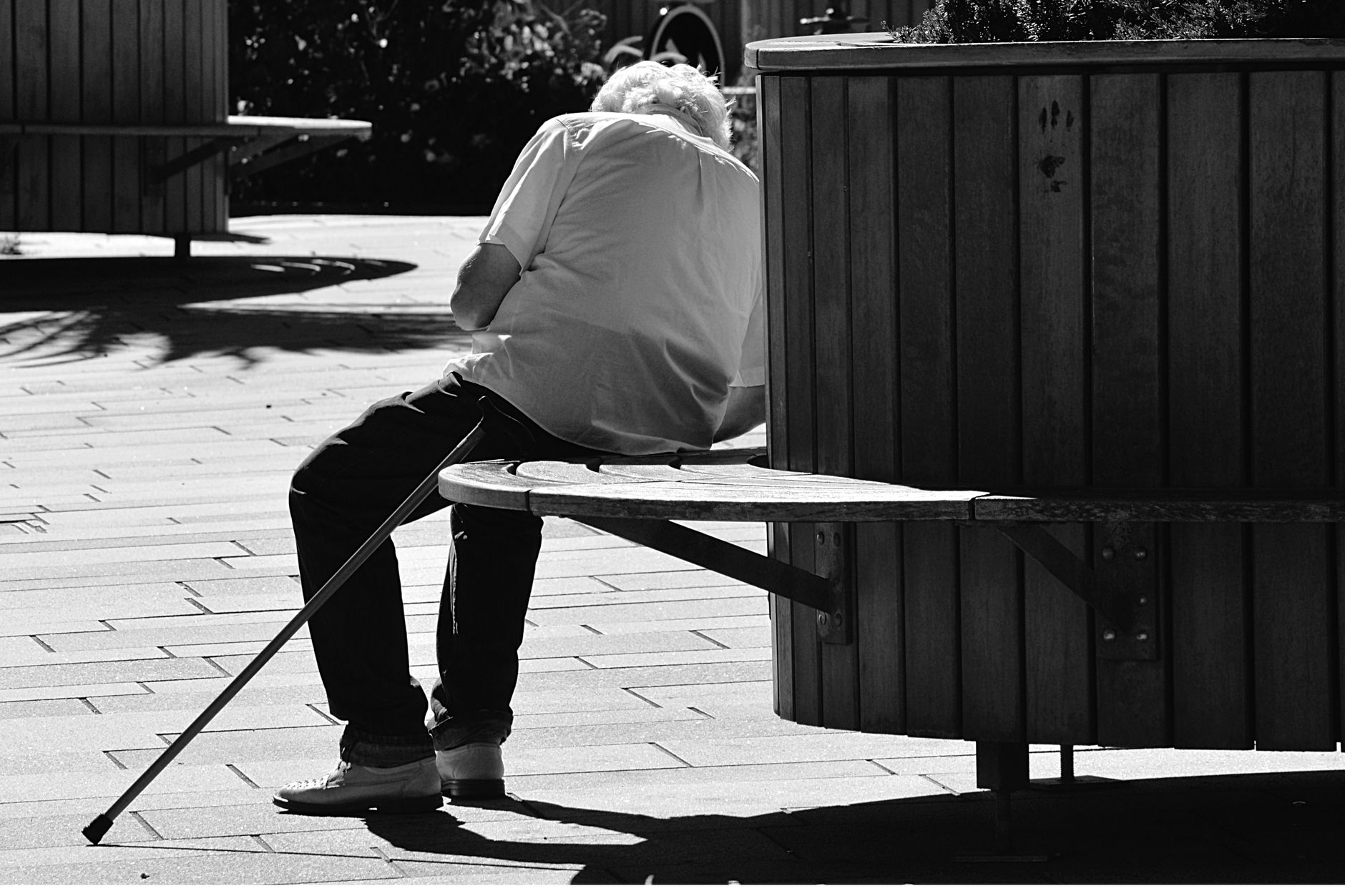Senior man pausing to rest after experiencing breathlessness during a walk