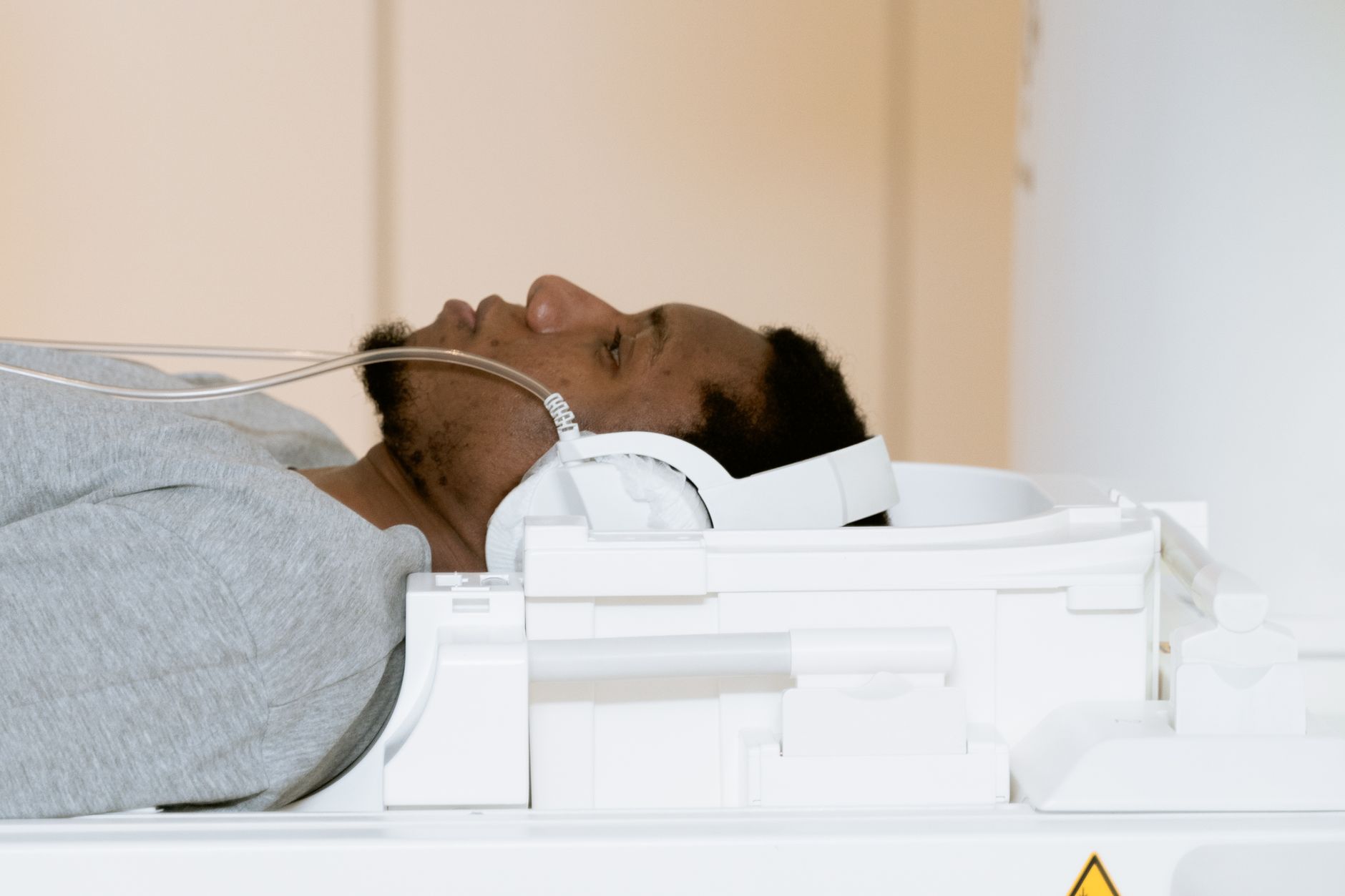 A patient lying comfortably on a CT scanner table during a non-invasive cardiac imaging scan
