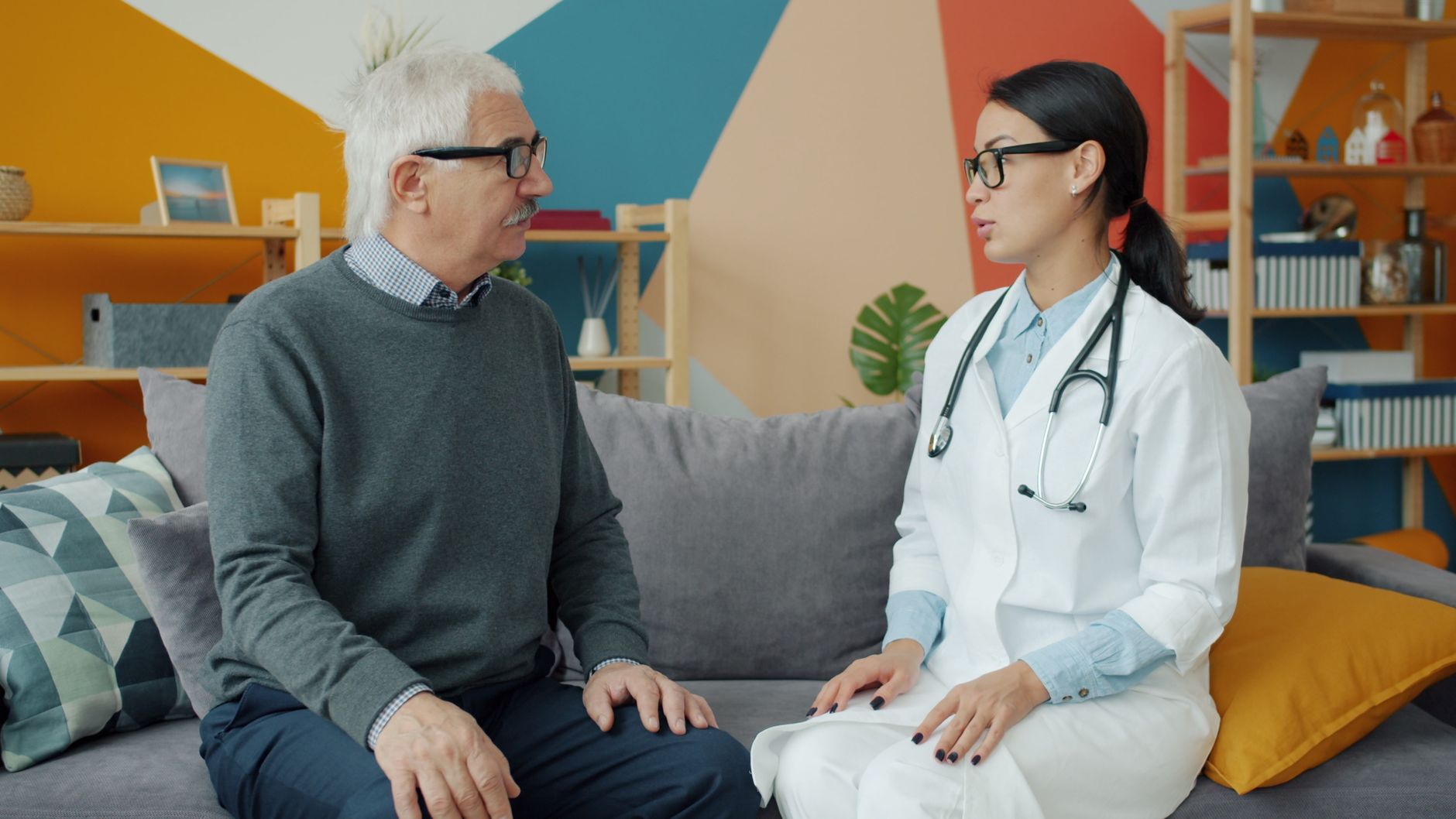 An elderly patient having a detailed conversation with a doctor during a cardiology consultation