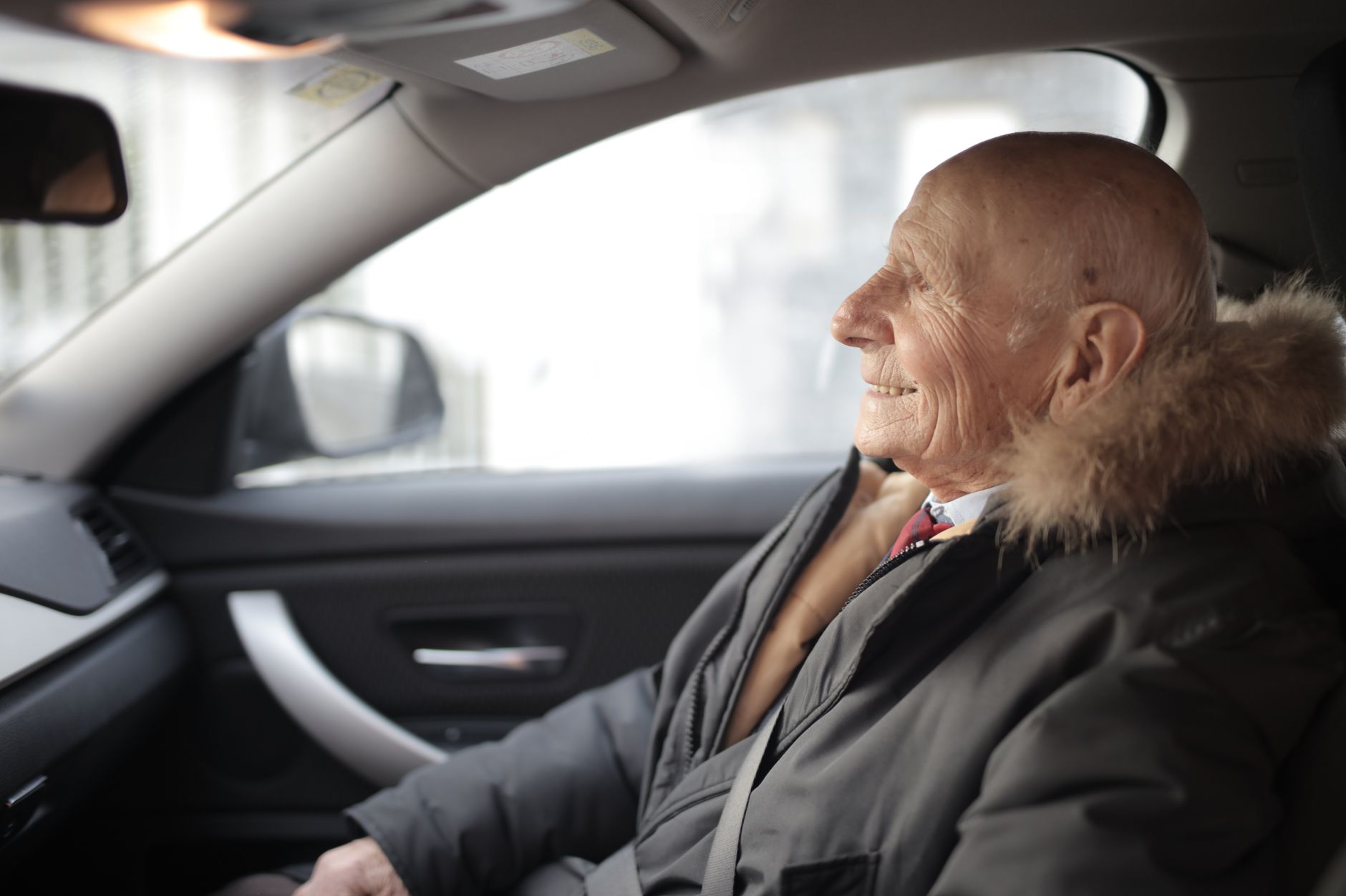 Senior man driving a car safely after receiving medical clearance following cardiac procedure