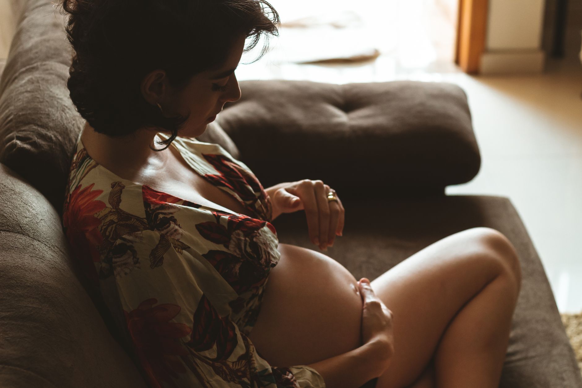 A pregnant woman resting comfortably at home, representing a healthy and calm pregnancy lifestyle