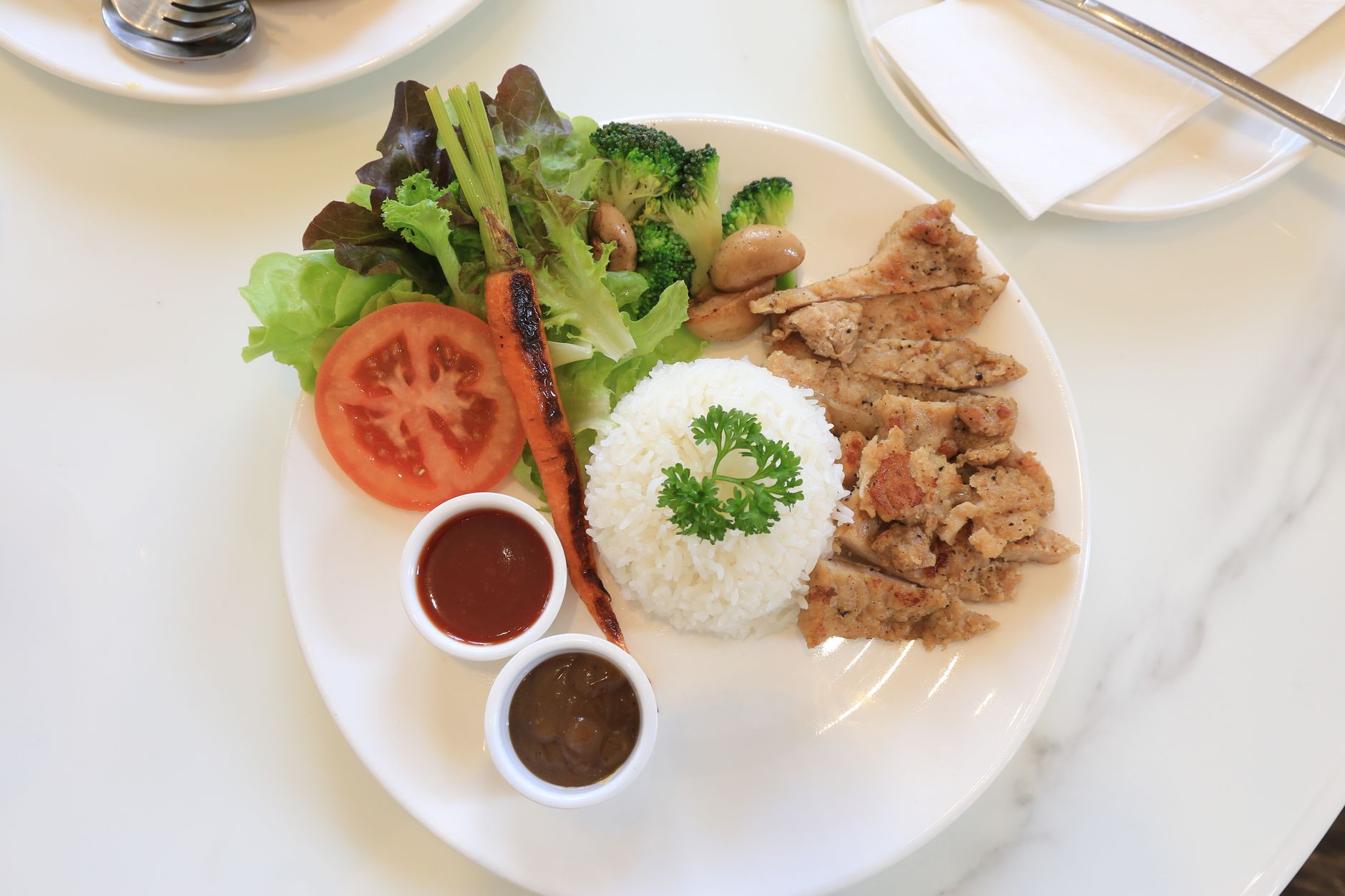 A balanced meal plate with vegetables, whole grains, and lean protein