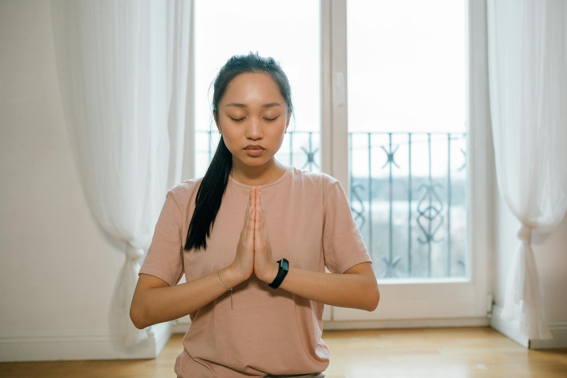 Woman practising yoga and breathing exercises indoors for cardiovascular wellness
