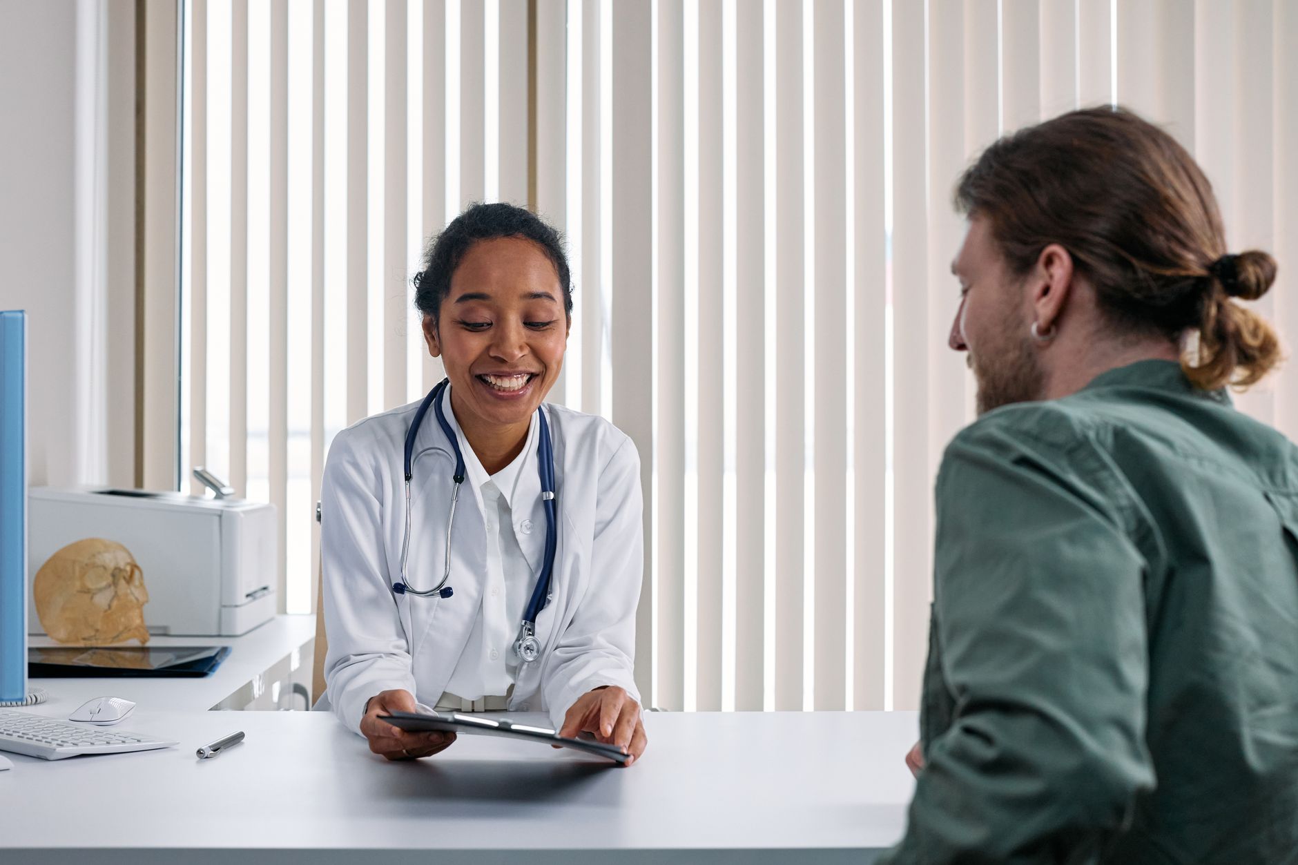 An elderly woman discussing her symptoms with a doctor during a cardiology consultation