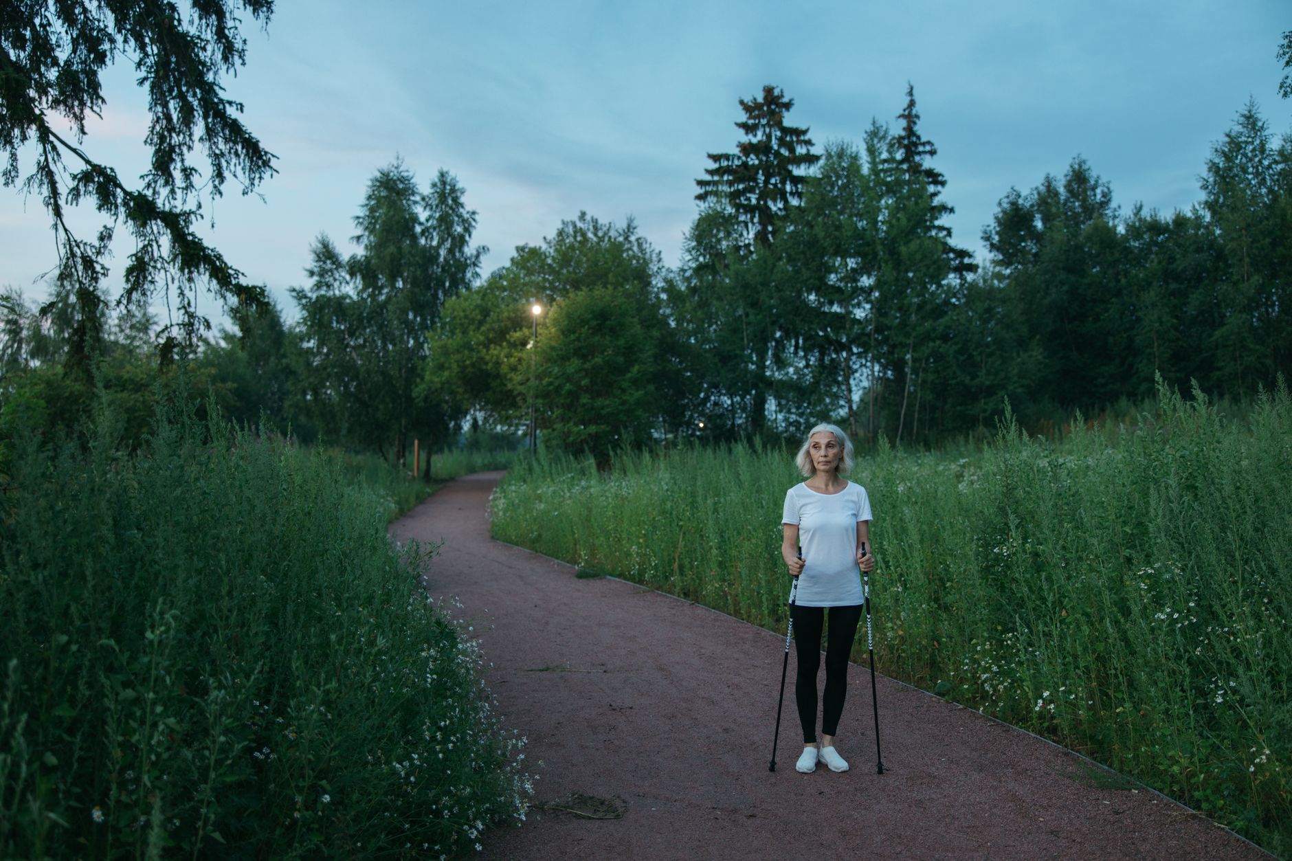 A woman enjoying a brisk walk in a park as part of a heart-healthy lifestyle