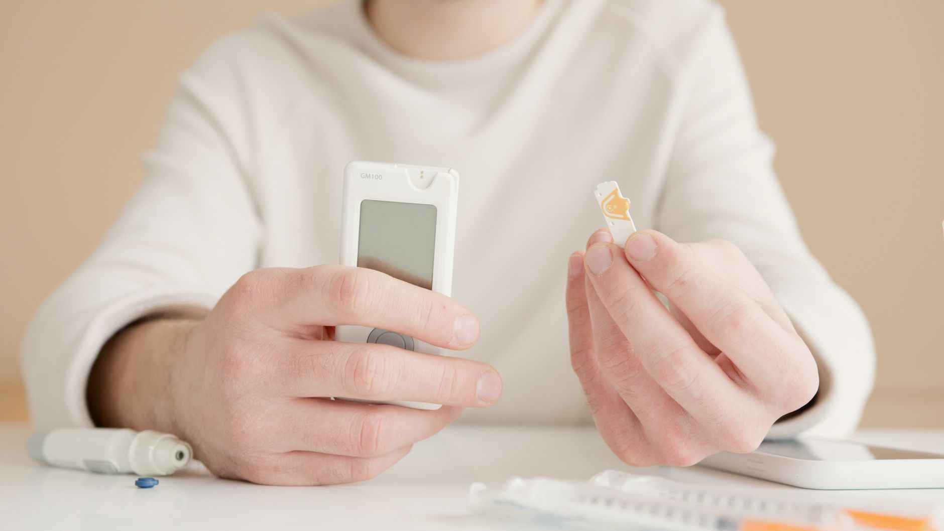 A doctor checking a patient's blood sugar level at a clinical consultation