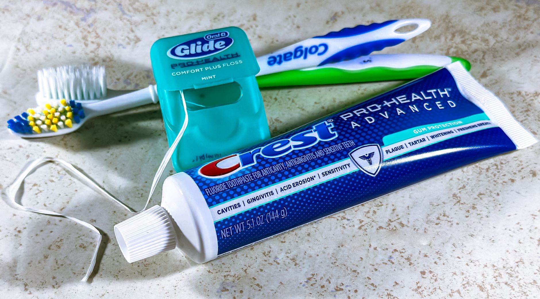 Toothbrush and dental floss on a bathroom counter, tools for good oral hygiene