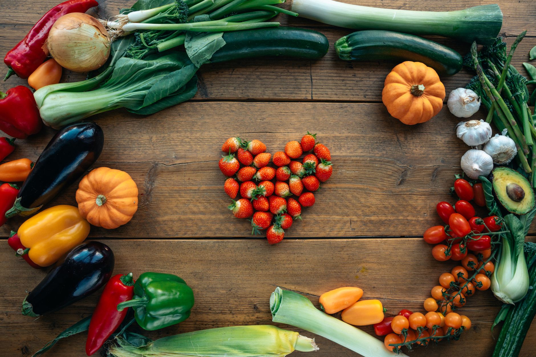 Colourful fruits and vegetables arranged in a heart shape, representing a heart-healthy diet