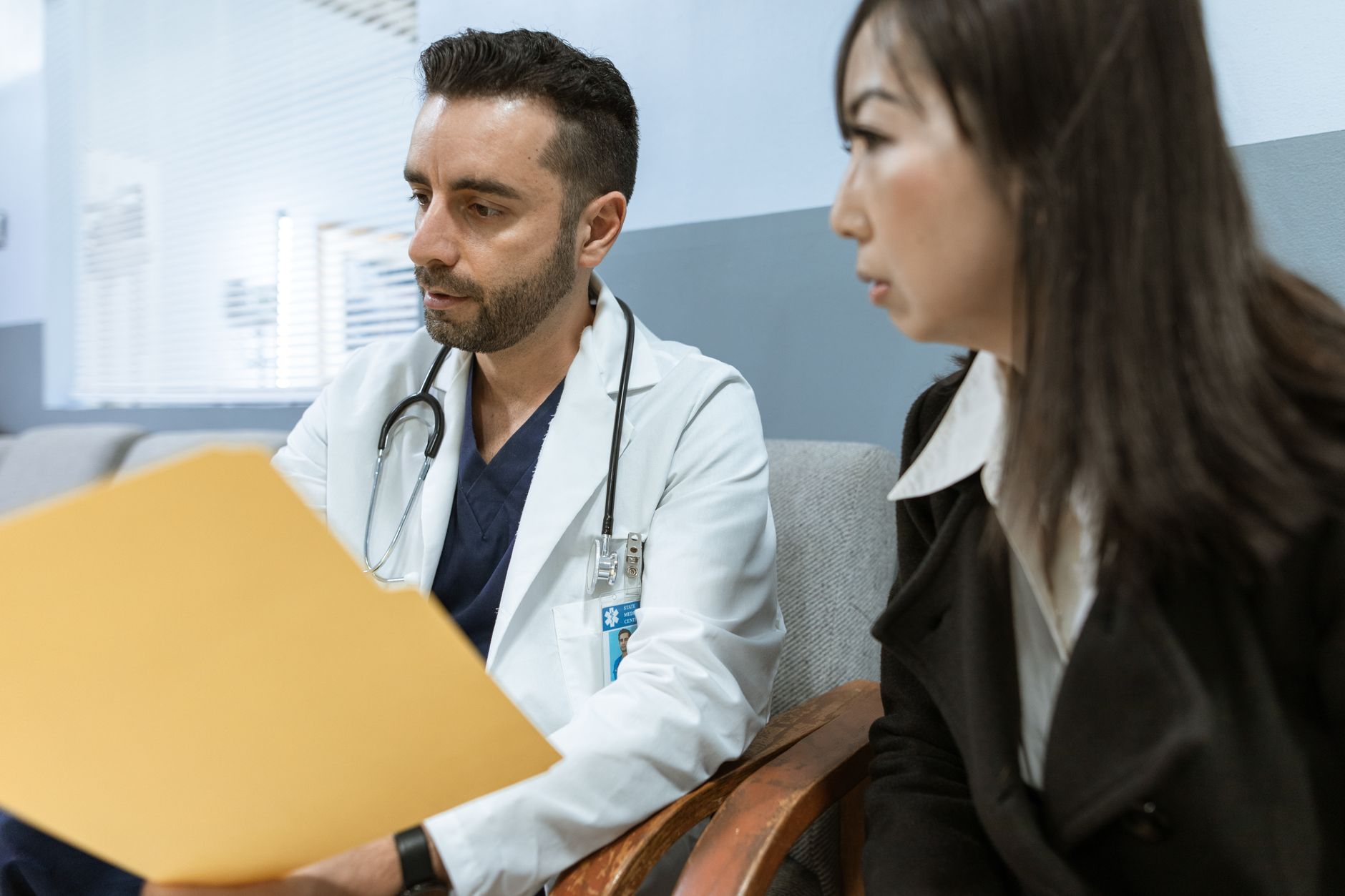 Female patient discussing heart health symptoms with a cardiologist
