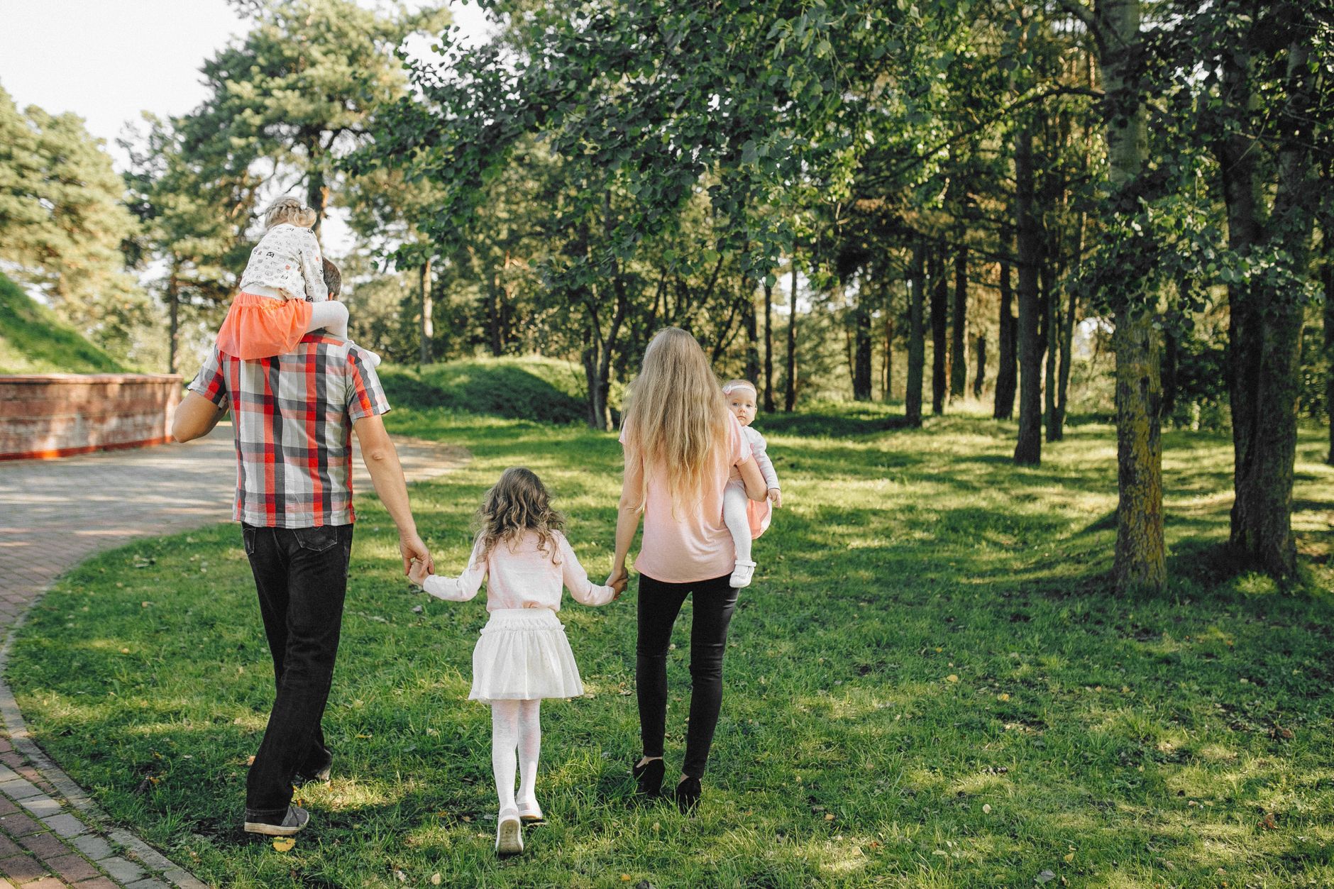A healthy family of different ages walking together in a park