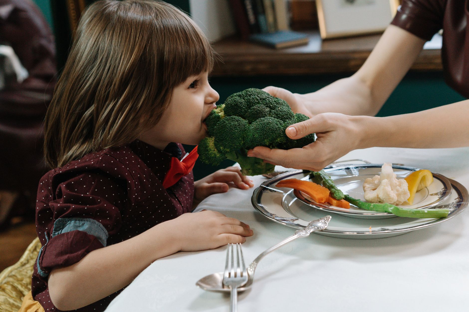 A child eating healthy food and staying active as part of heart health habits