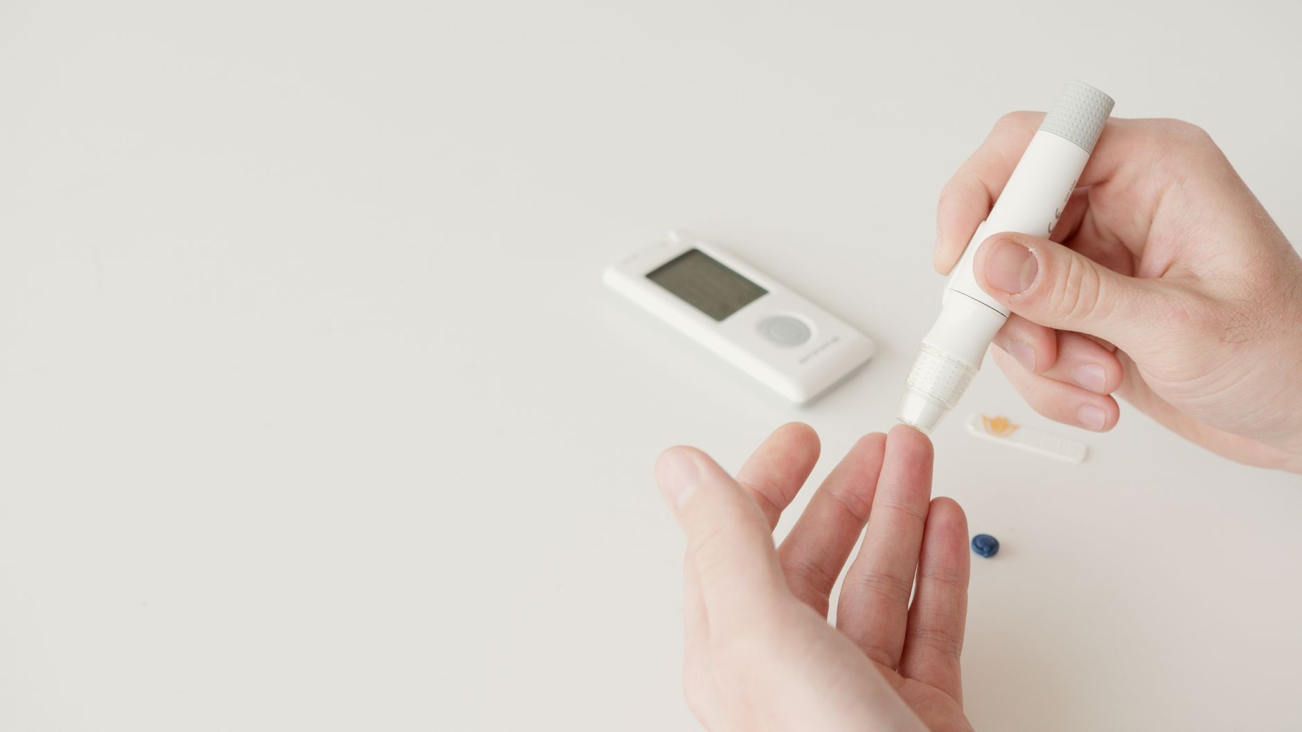 A person checking their blood sugar level using a glucometer at home