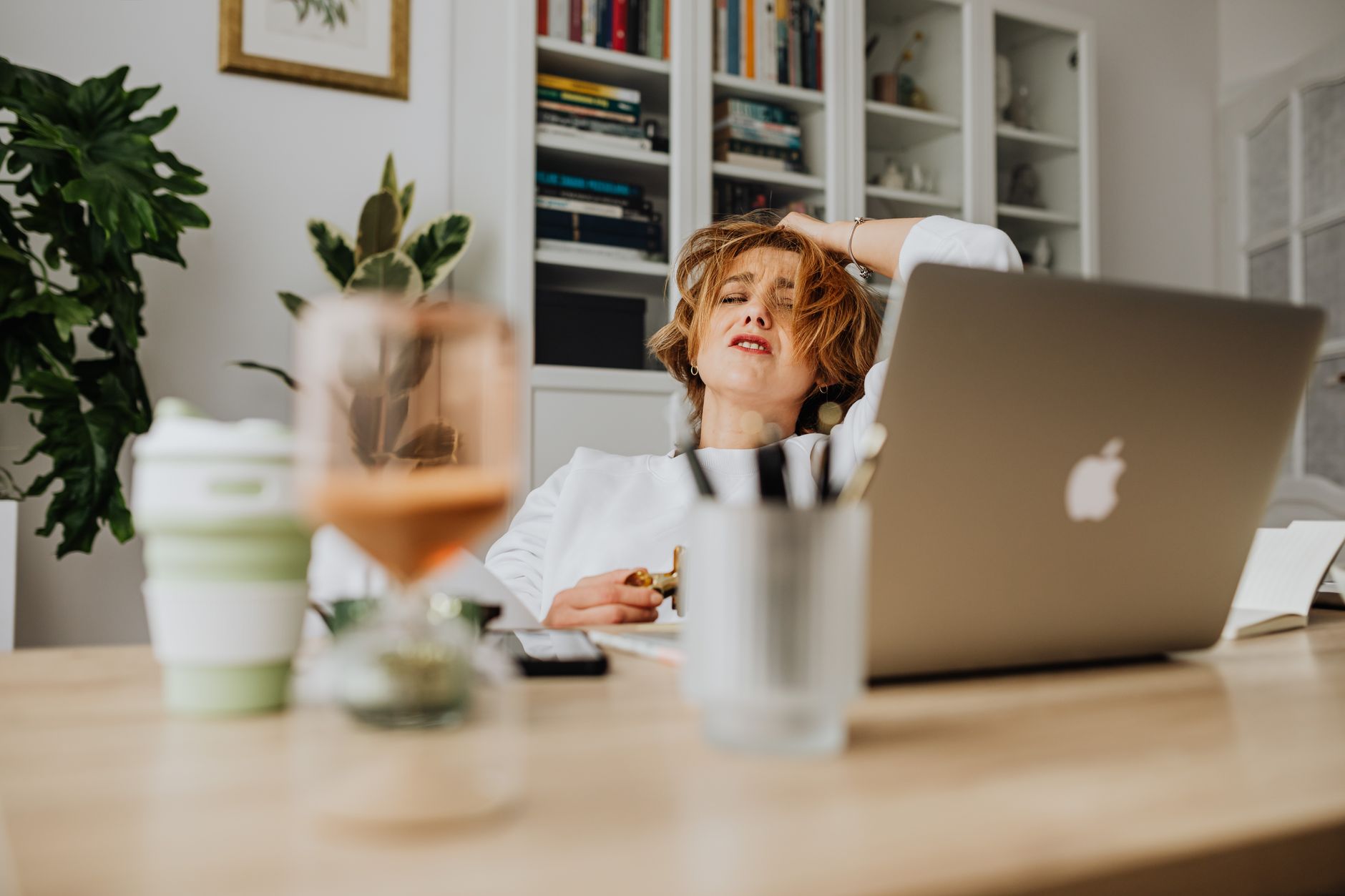 A woman managing stress while working, highlighting the link between chronic stress and heart health