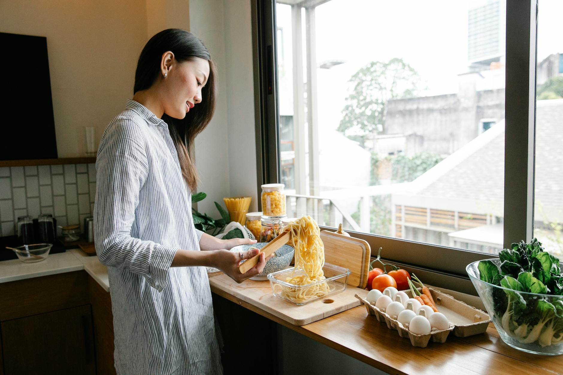 A woman preparing a healthy home-cooked meal using heart-friendly ingredients