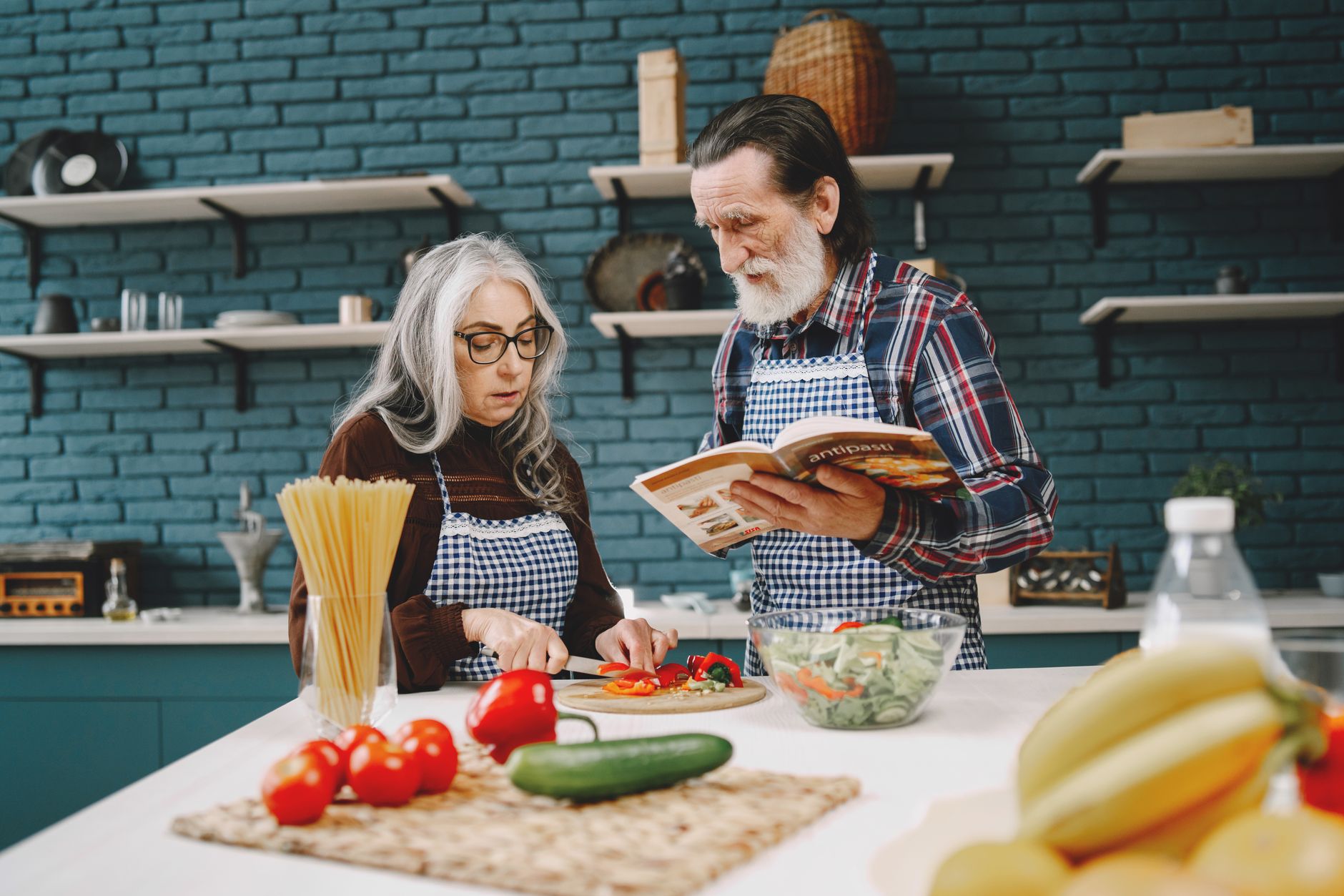 An older couple preparing a healthy meal together in their home kitchen