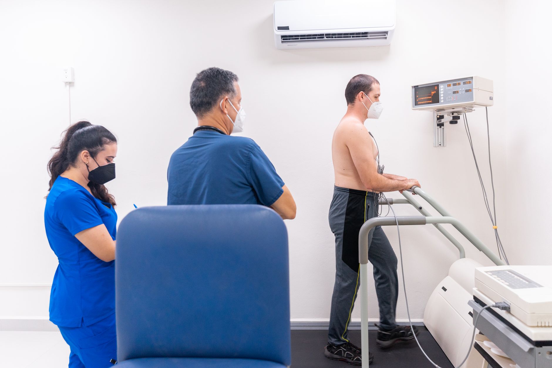 A doctor reviewing treadmill stress test results with a patient in a cardiac clinic