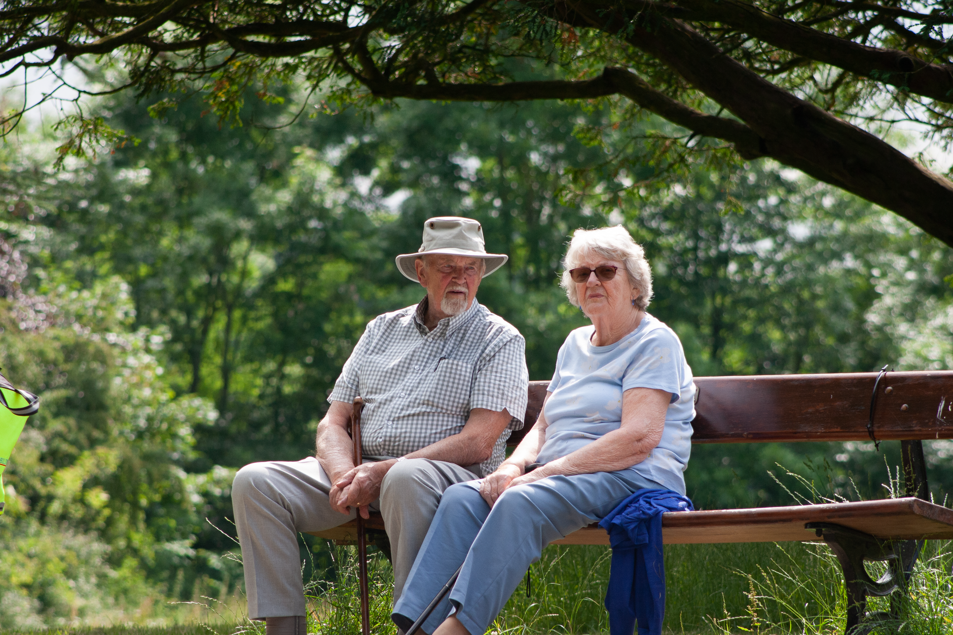 An older couple taking a comfortable rest in the shade during an outdoor event