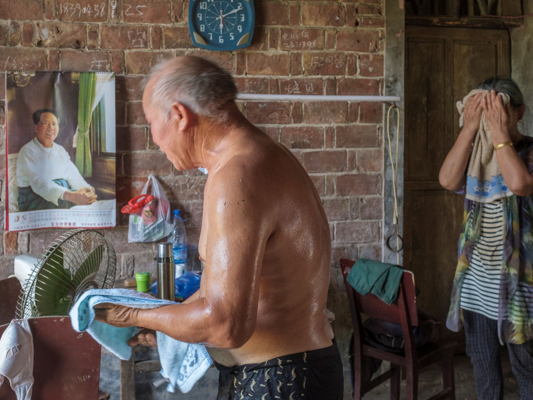 An elderly couple resting comfortably indoors during a hot summer day