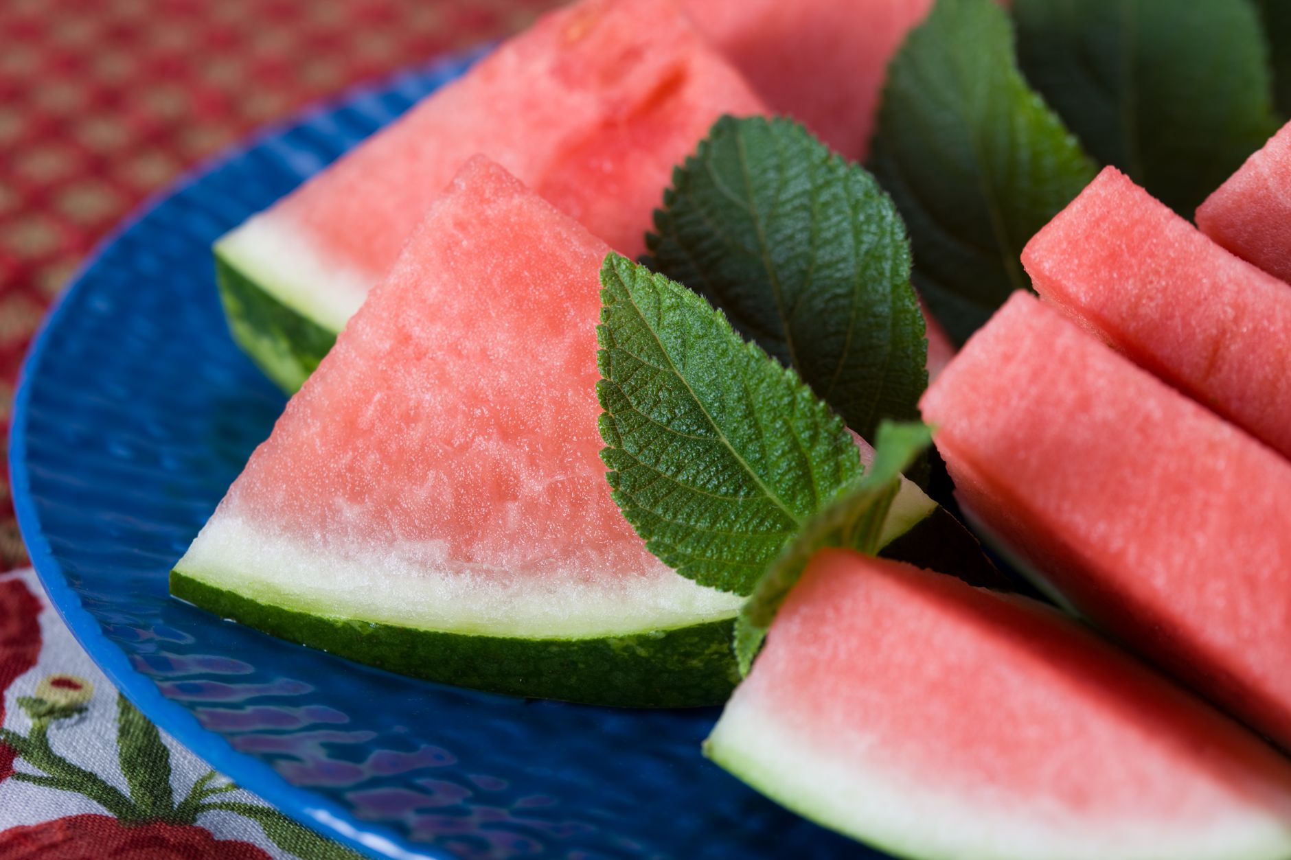 A plate of fresh fruits and vegetables that support heart health and hydration during summer