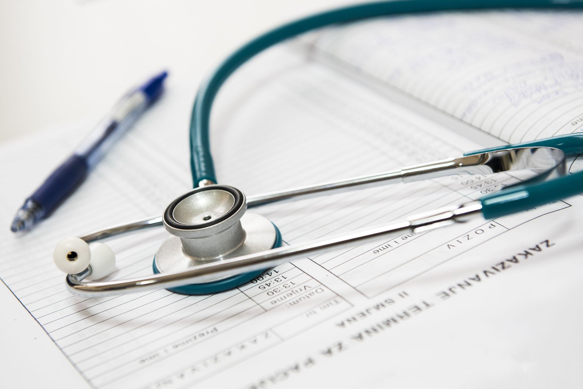 A lipid profile blood test report on a doctor's desk alongside a stethoscope