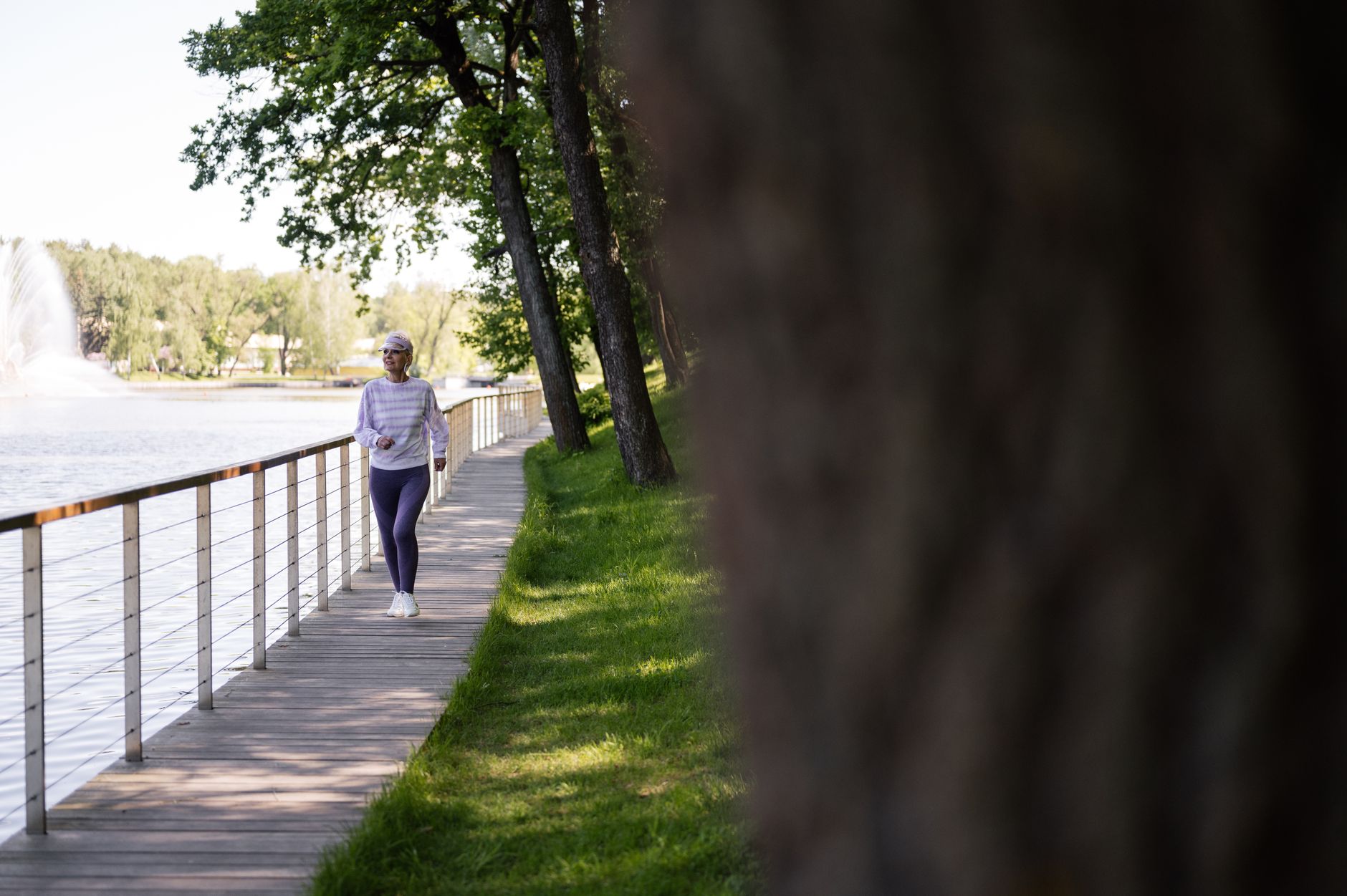 A person enjoying a brisk morning walk in a park as part of a heart-healthy lifestyle
