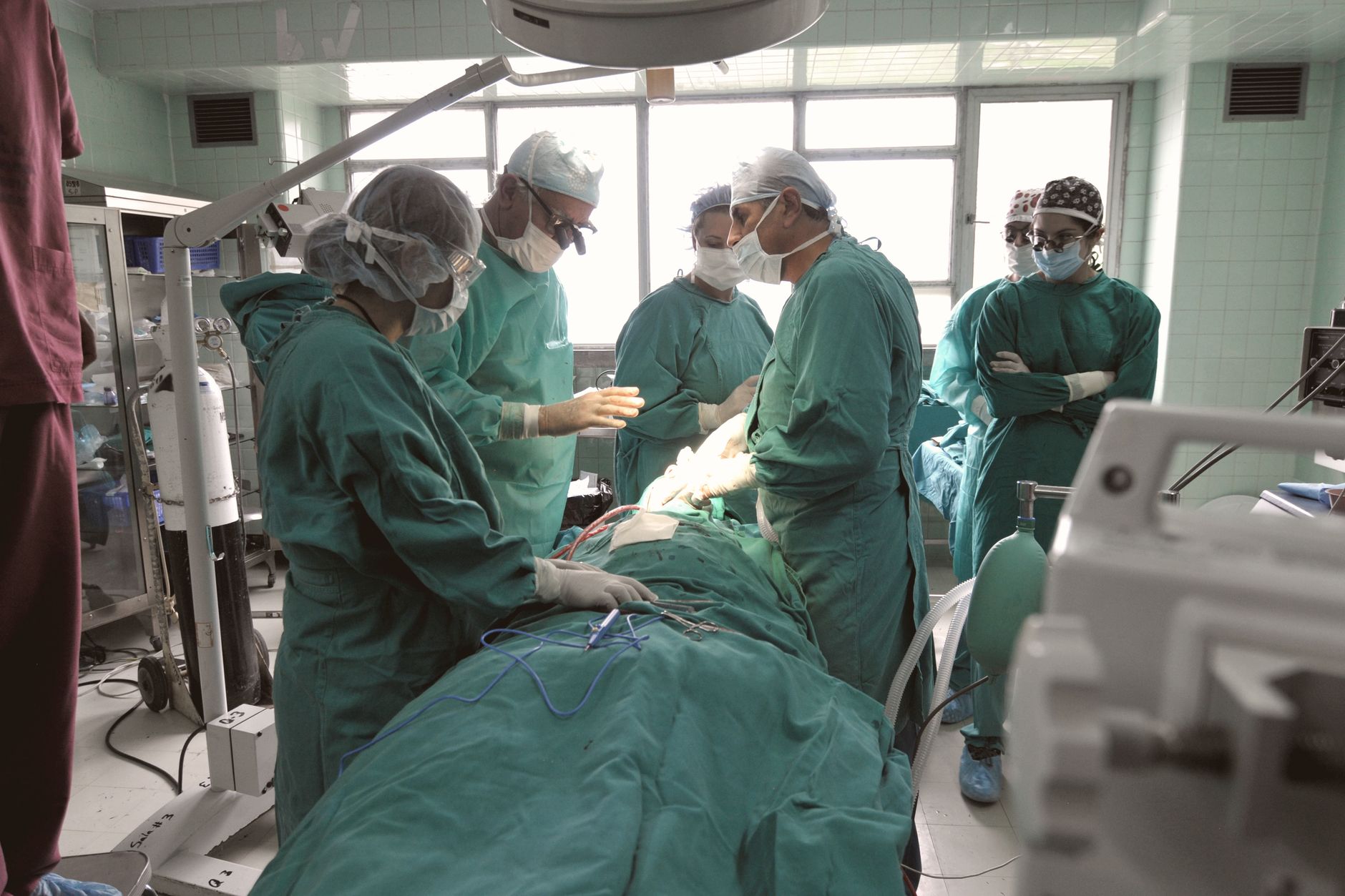 A cardiac surgical team working in a modern operating theatre during heart valve surgery