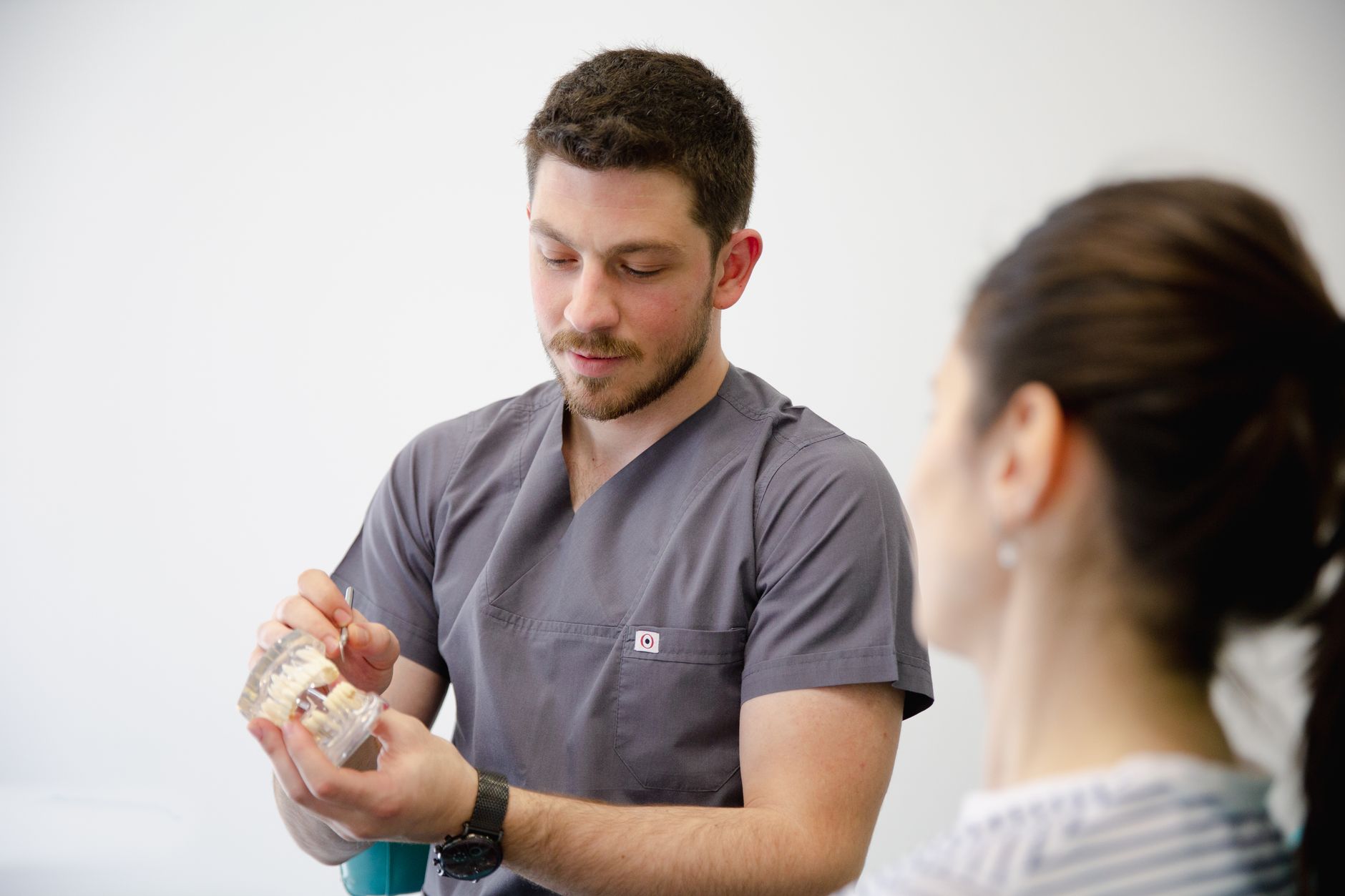 Doctor using a heart model to explain a cardiac procedure to a patient