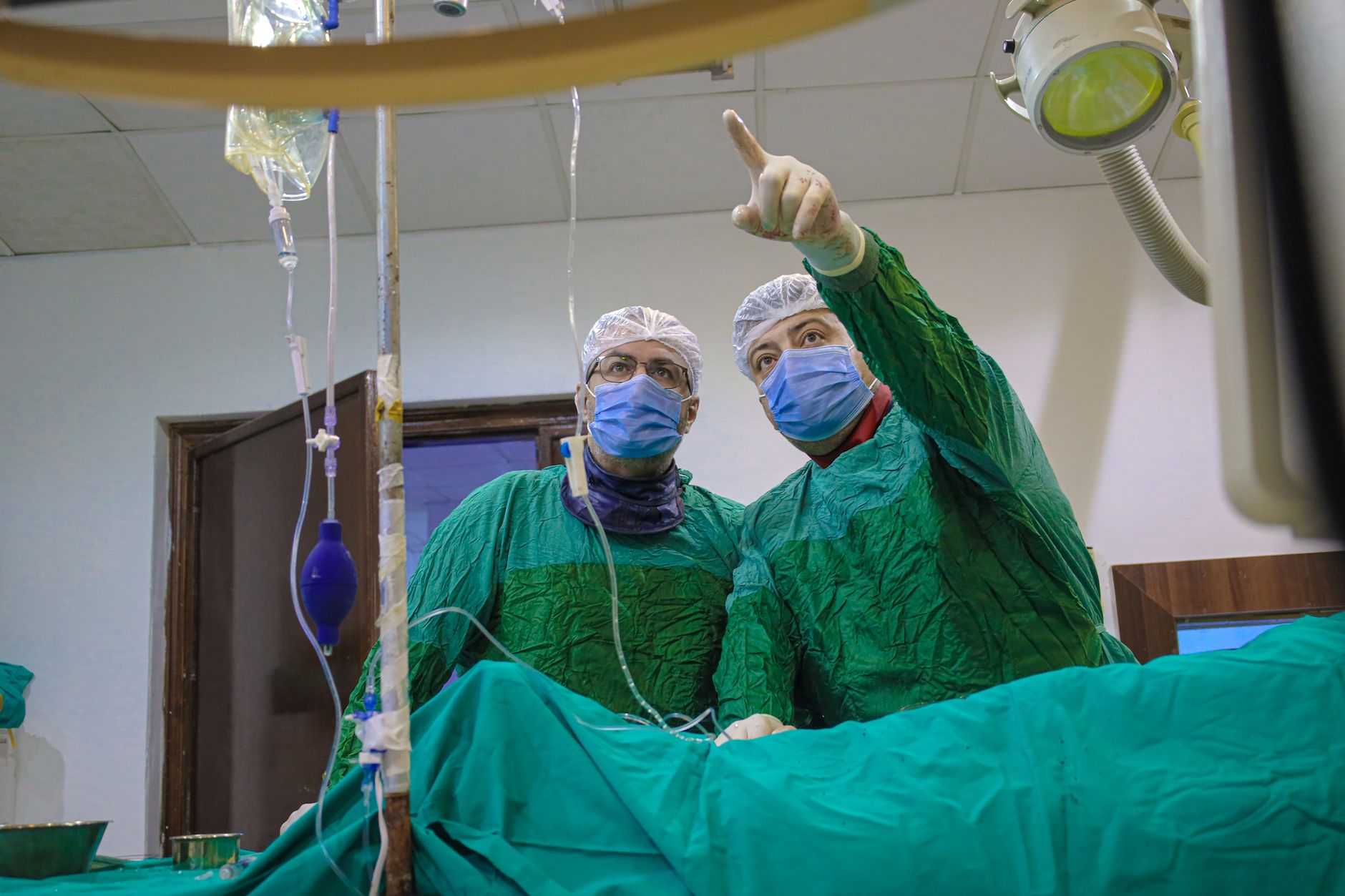 Medical team in a cardiac catheterization laboratory preparing for a minimally invasive heart procedure