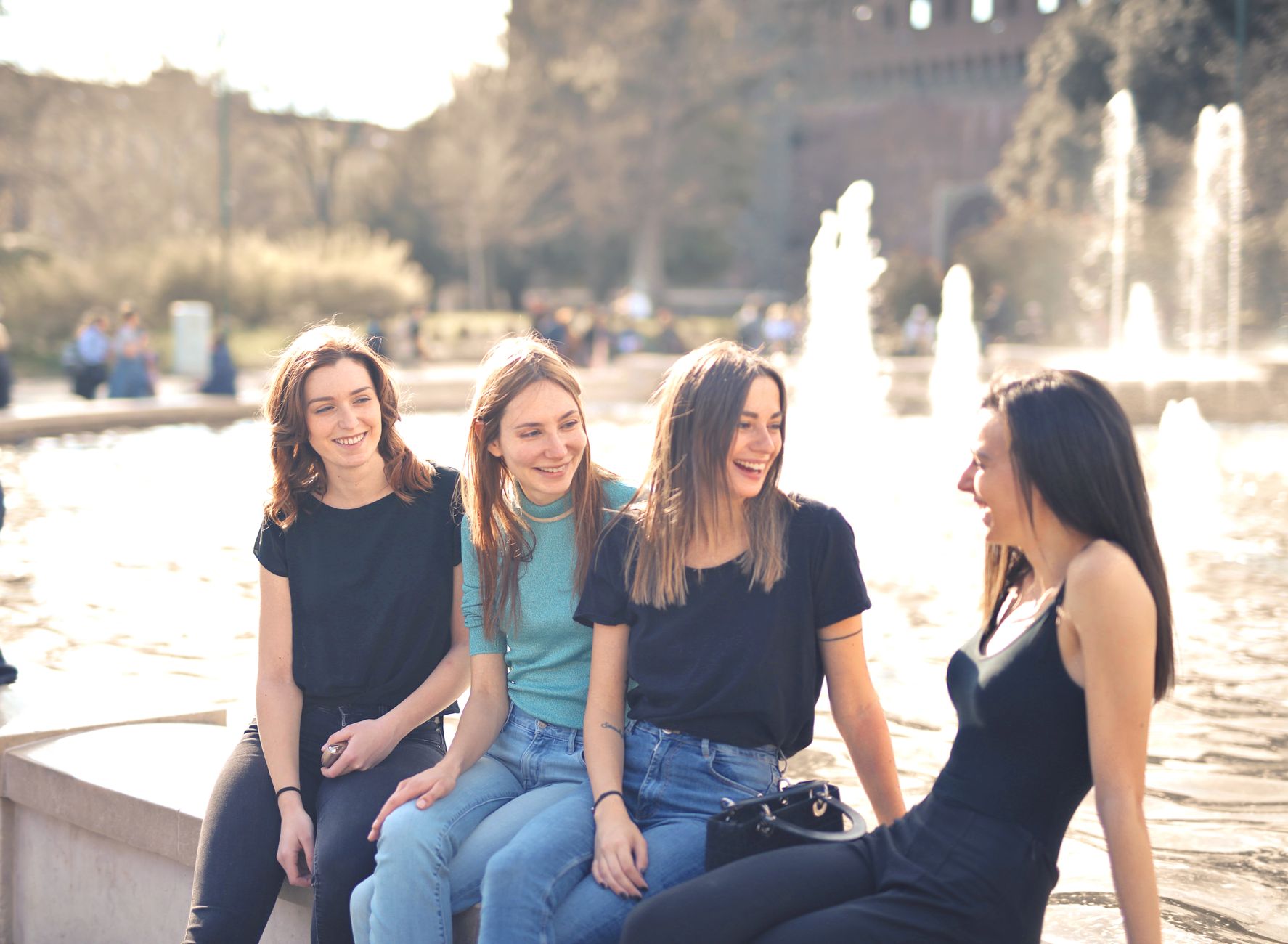A group of friends enjoying a conversation outdoors, representing social connection and community