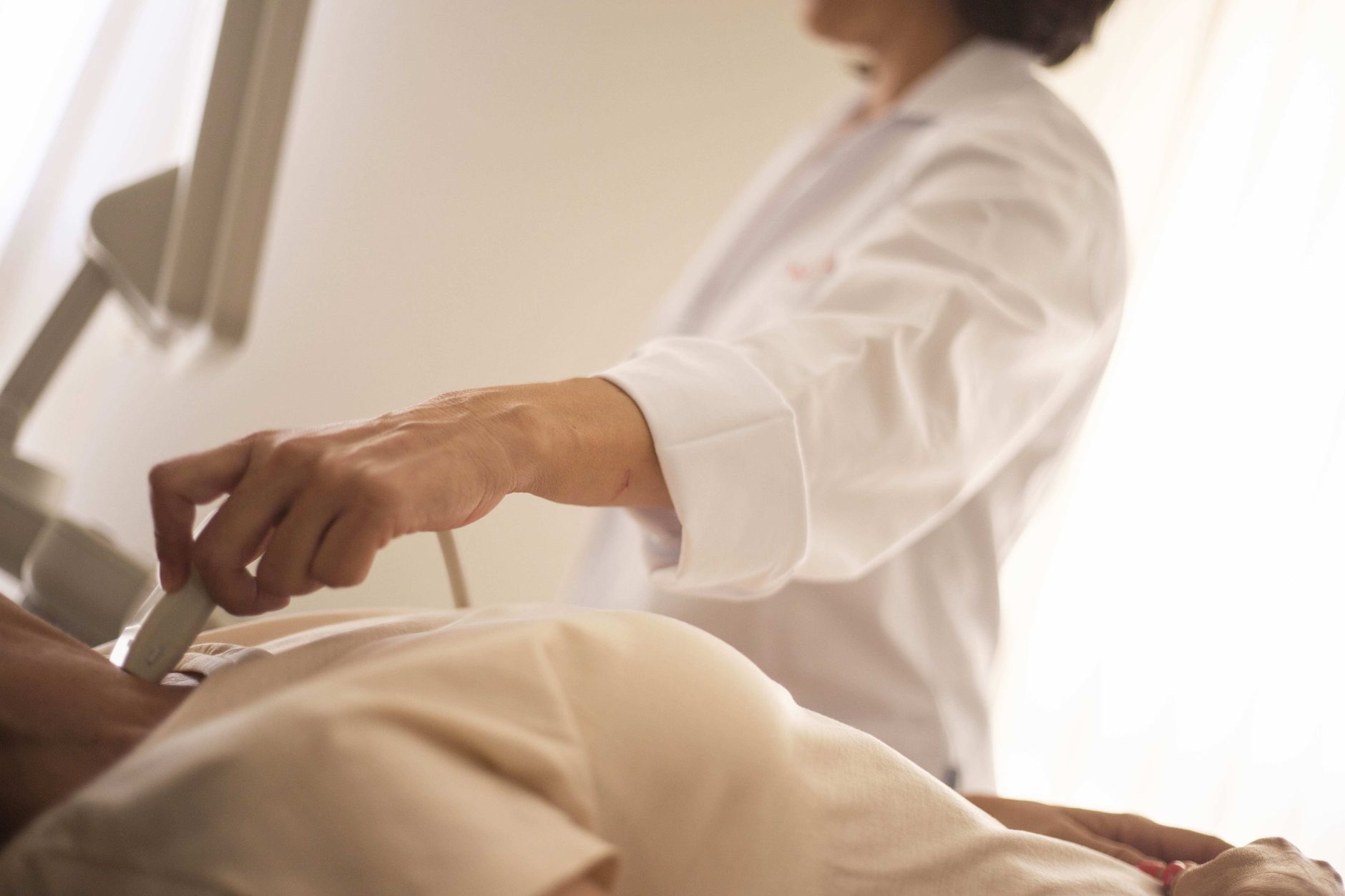 A doctor performing an echocardiogram to monitor the aorta in a patient with a connective tissue disorder