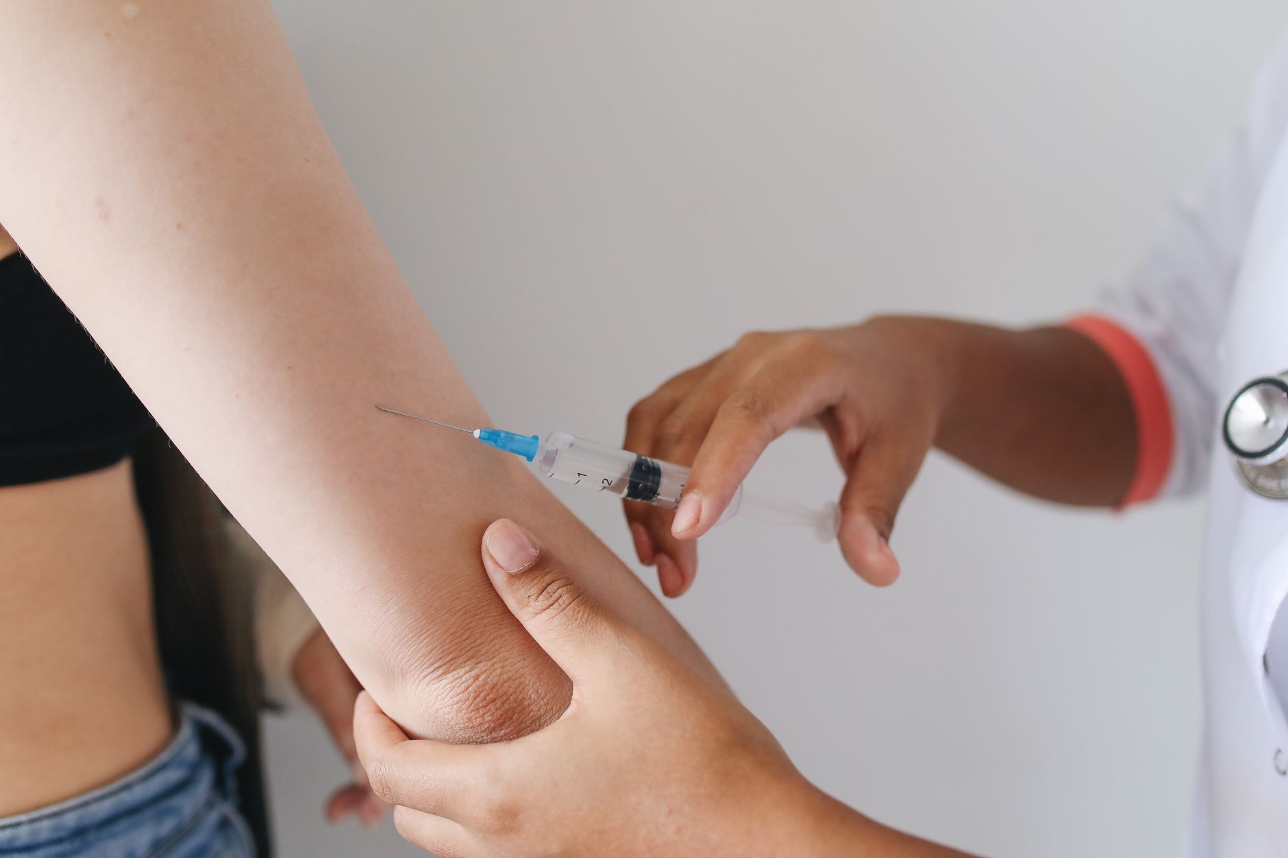 Doctor administering a subcutaneous injection to a patient's arm