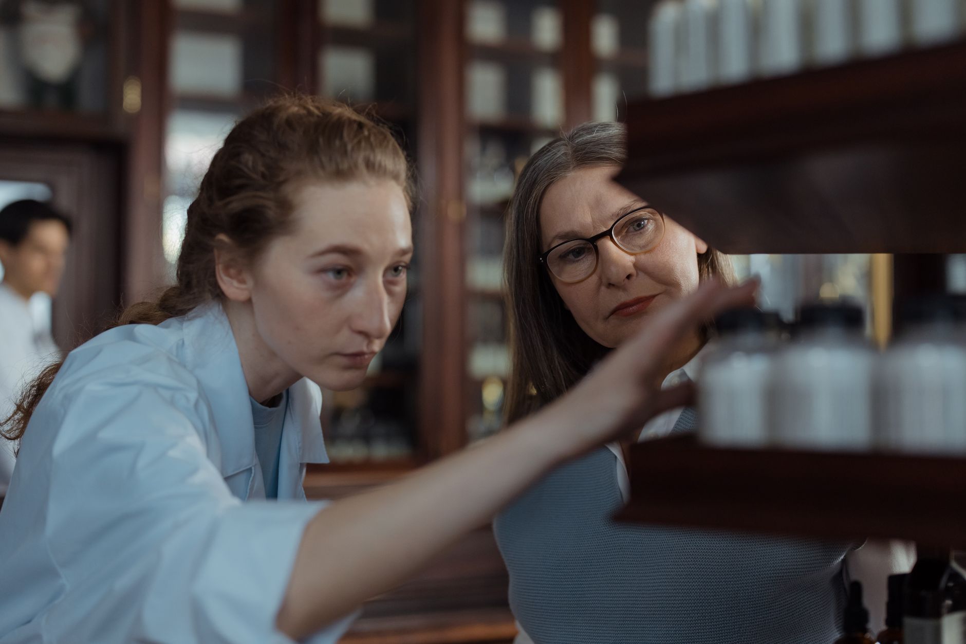 A pharmacist or doctor explaining prescribed heart medications to a patient