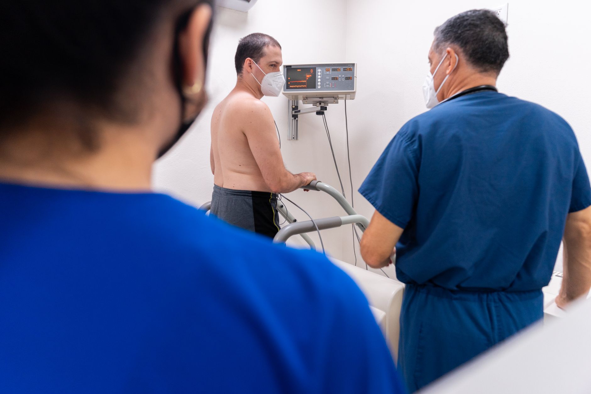 An interventional cardiologist performing a catheter-based procedure in a cardiac catheterisation laboratory