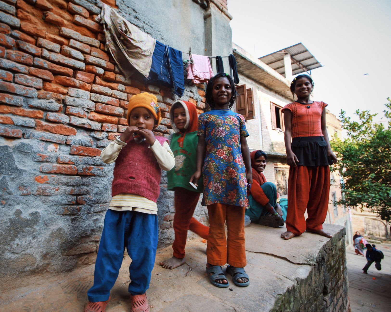 Children playing in a crowded urban neighbourhood, illustrating environments where strep throat spreads easily
