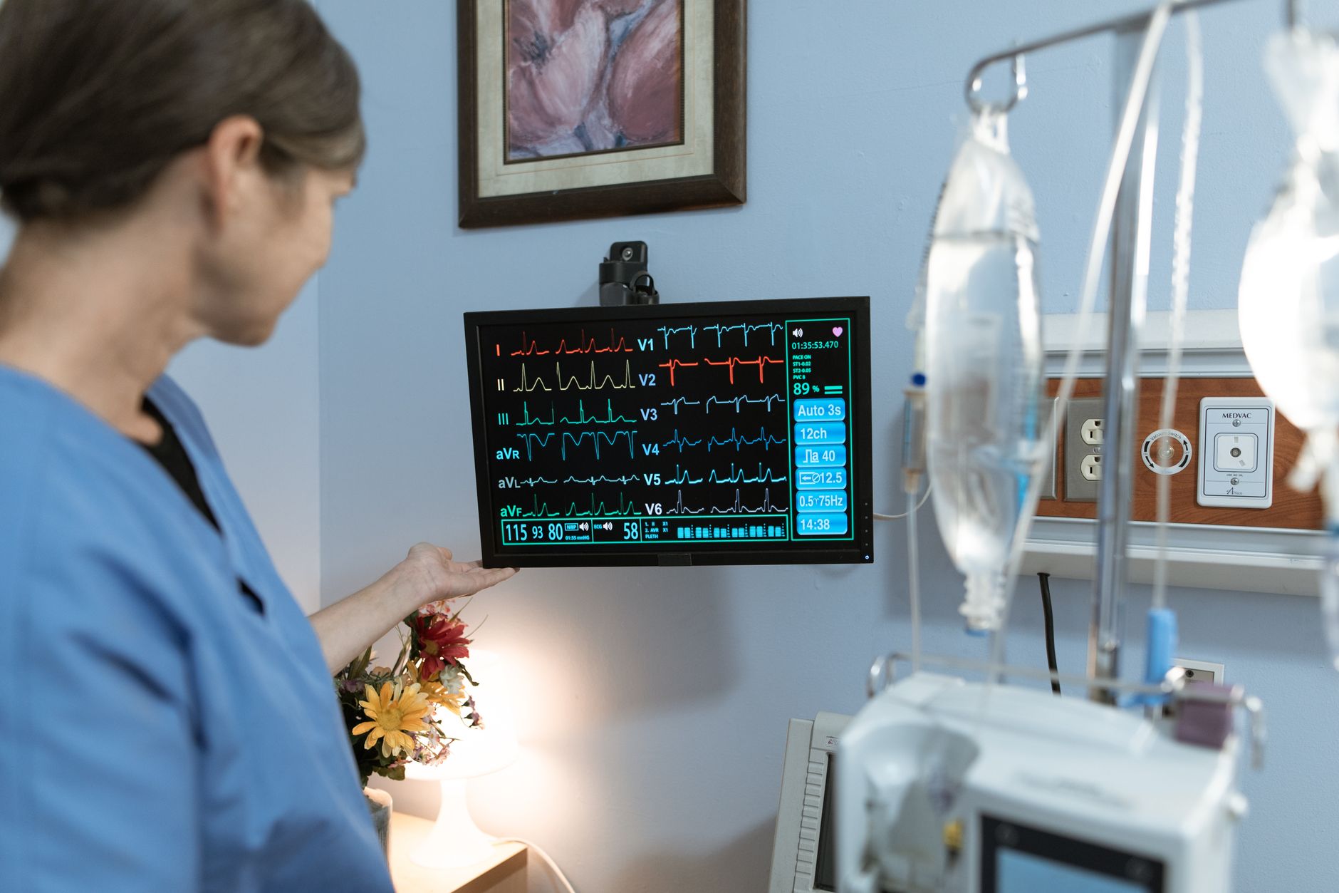 Cardiologist reviewing ECG monitor results in a hospital setting
