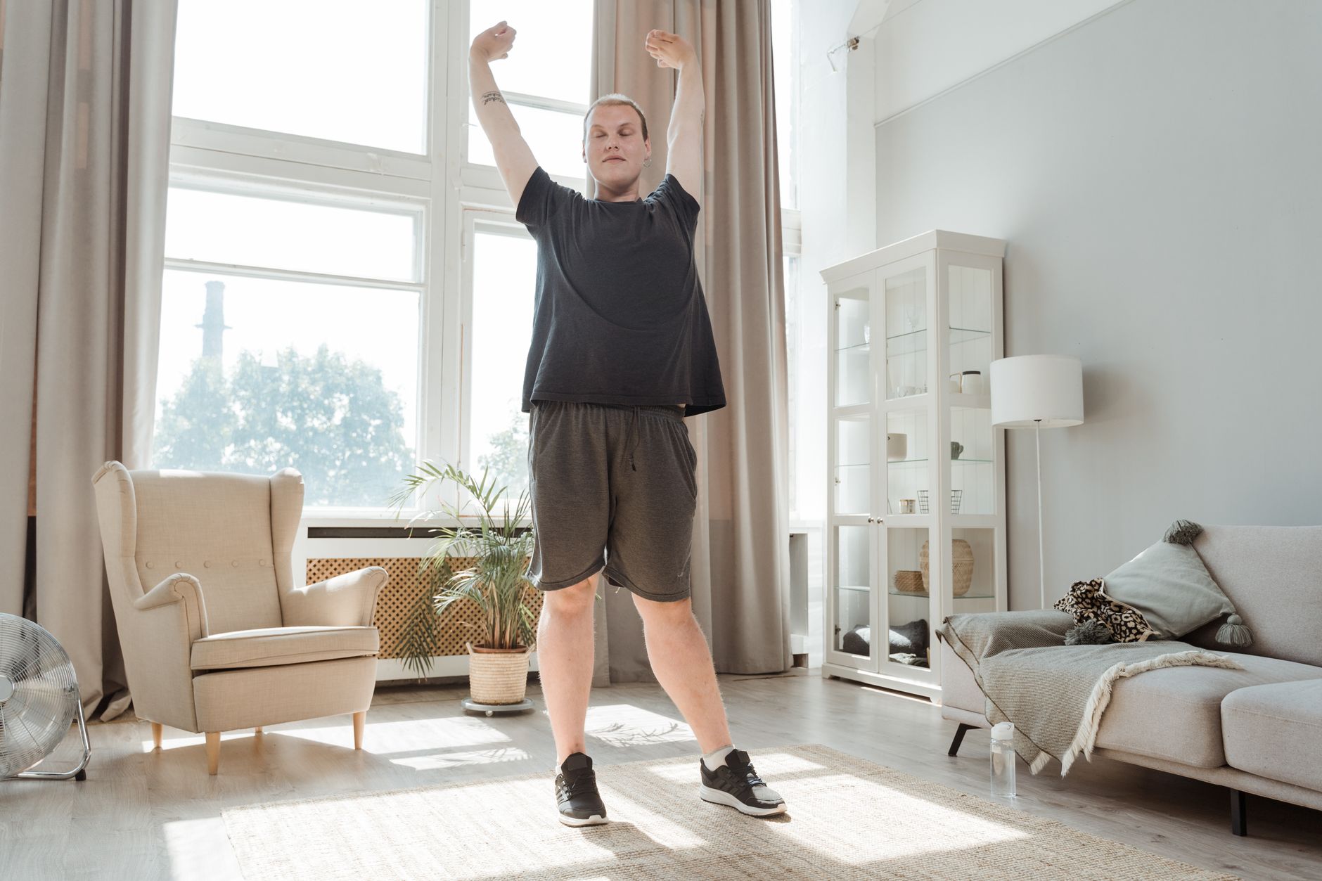 A person doing gentle stretching exercises at home as part of cardiac rehabilitation