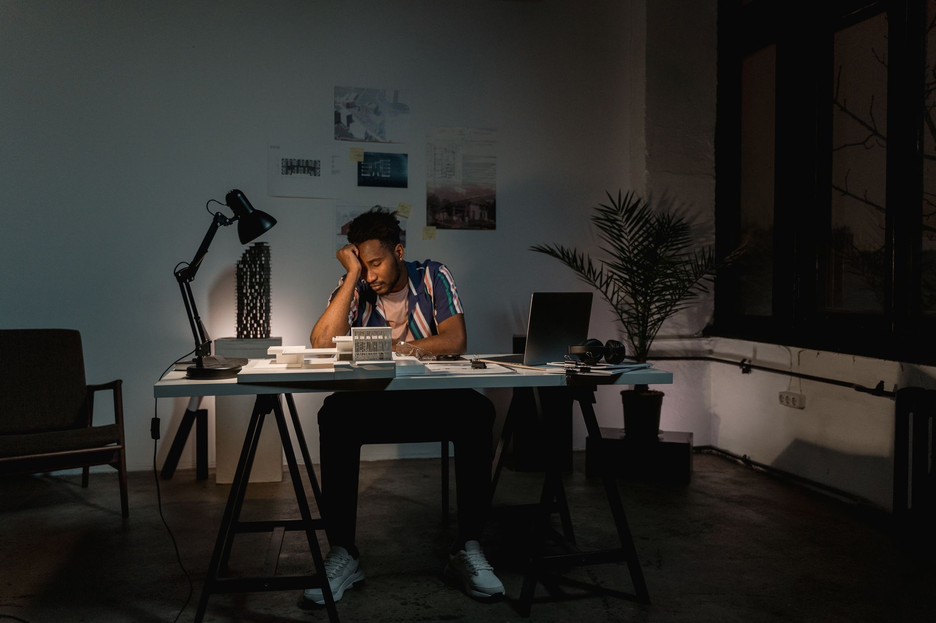 A professional working late at a laptop, illustrating work stress as a cardiovascular risk factor