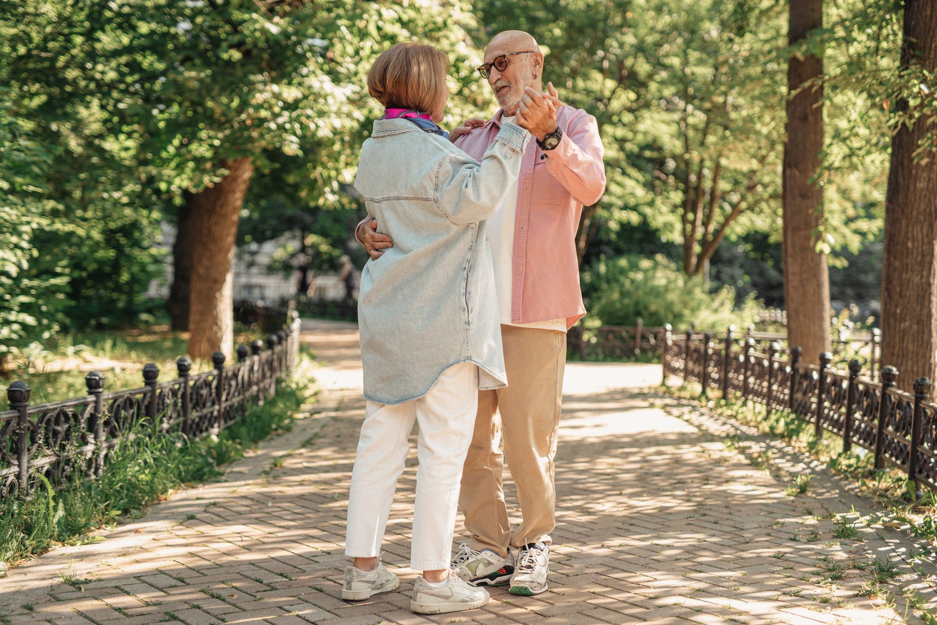 Senior couple enjoying a morning walk in the park for heart health