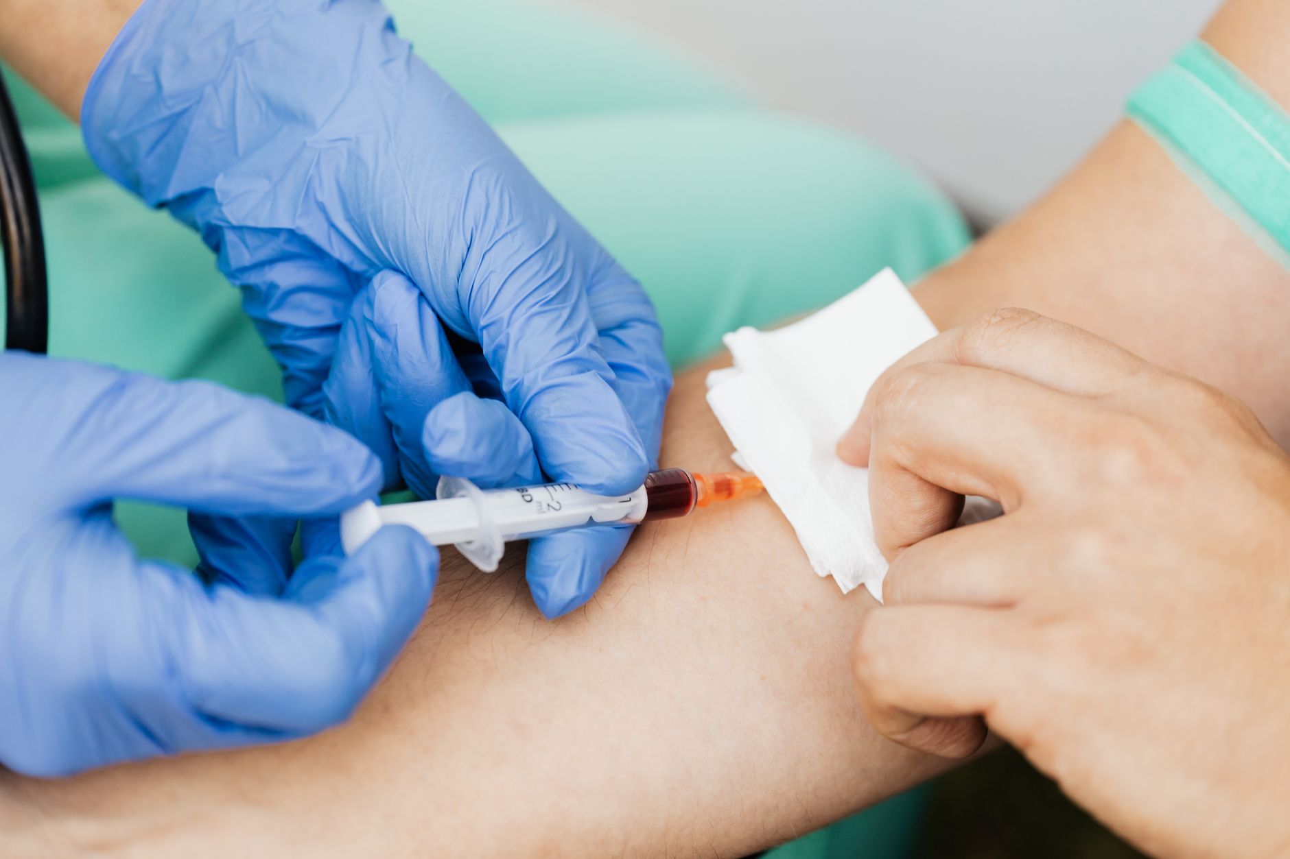 A nurse drawing a blood sample from a patient for cardiac biomarker testing