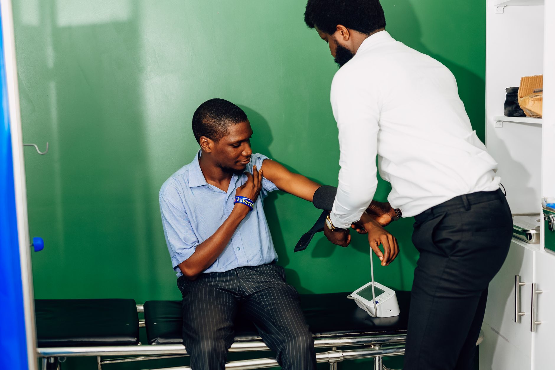 A doctor checking a patient's blood pressure during a cardiology consultation