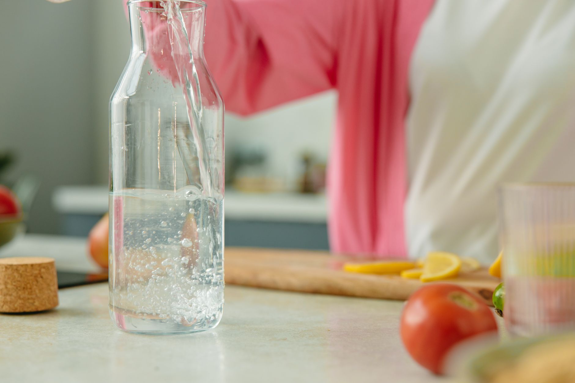 Healthy fruits, vegetables, and a water bottle representing a heart-healthy diet and hydration