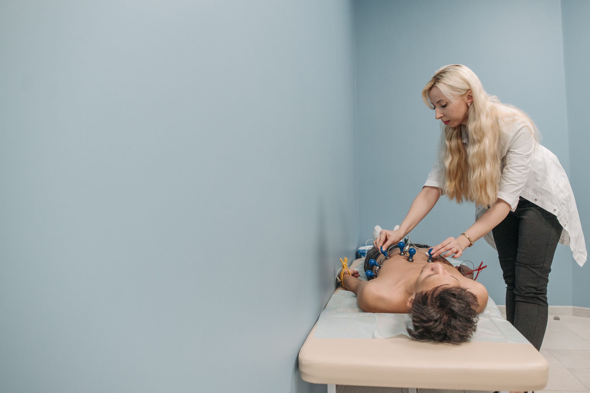 A doctor reviewing an ECG report with a patient in a cardiology clinic